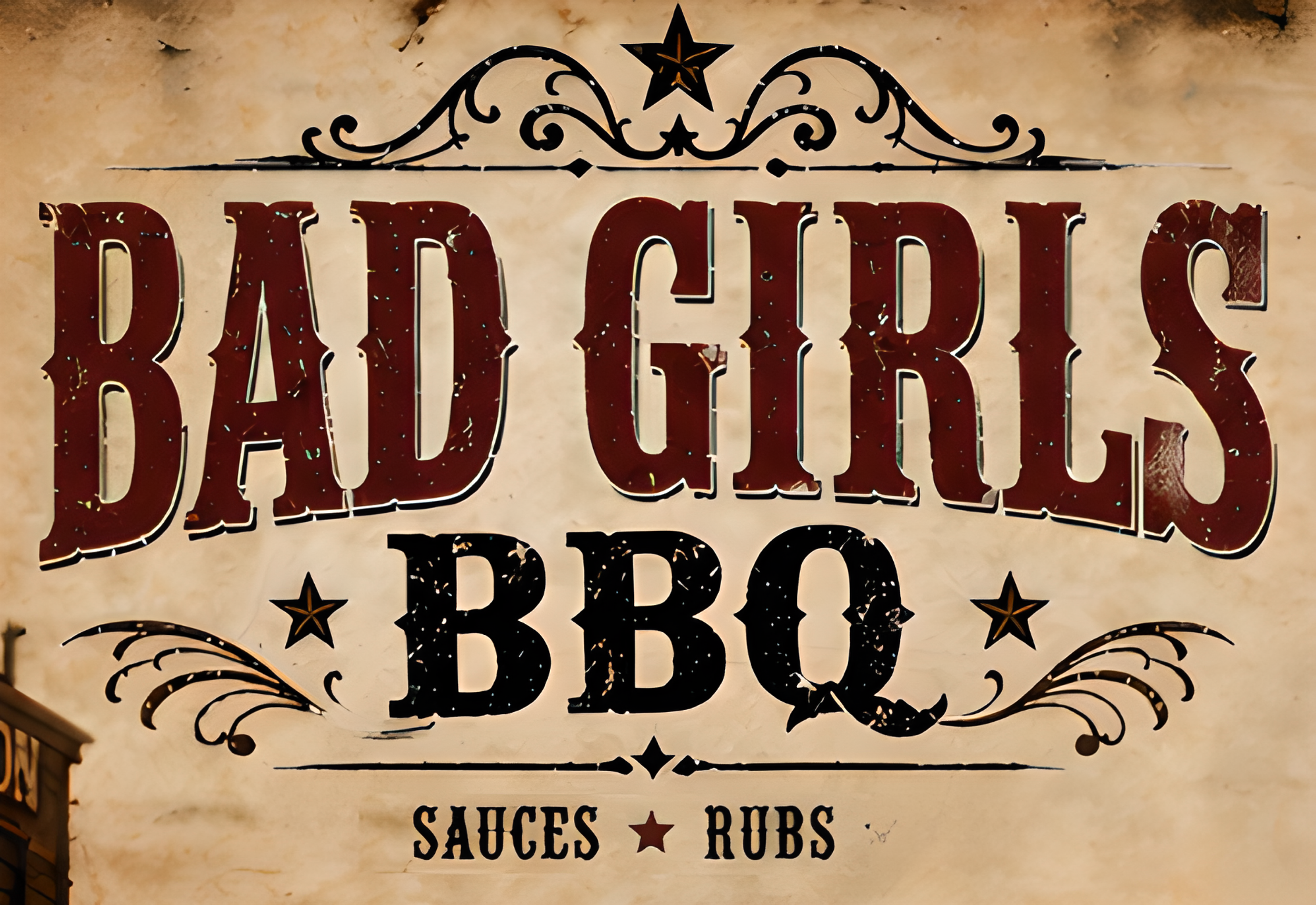 Decorative sign with vintage style, featuring stars and swirling designs, listing menu items: 'Baked', 'Salsas', 'Ribs', 'BBQ'.