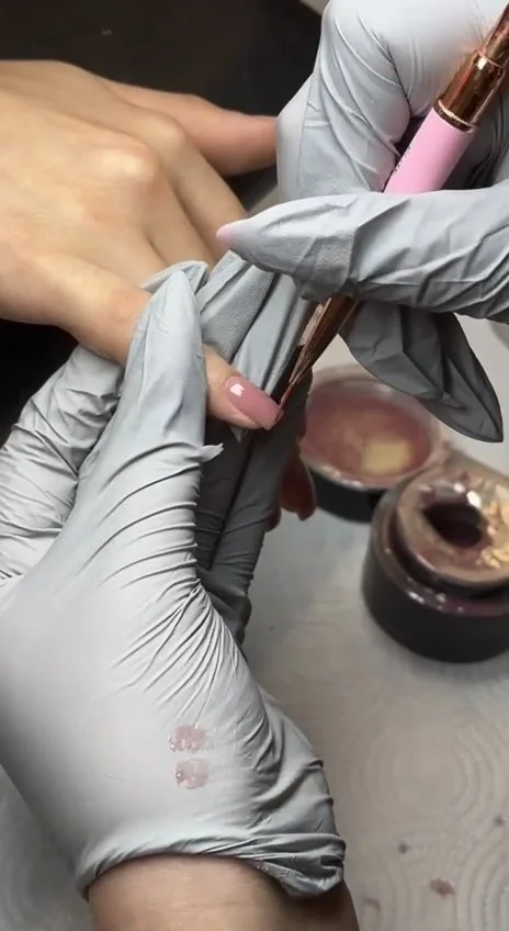 Nail tech practicing controlled gel application