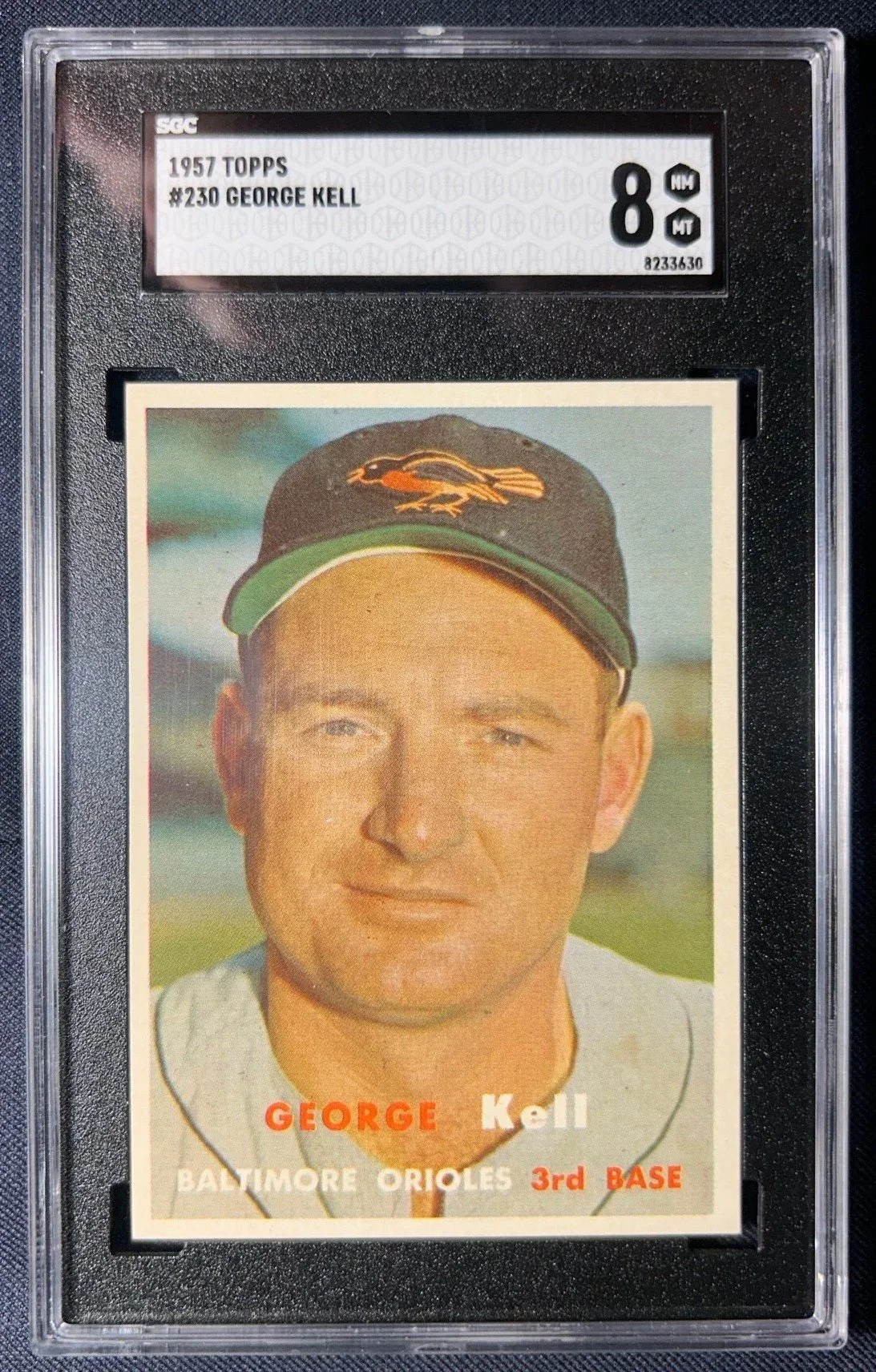 Vintage 1957 Topps baseball trading card of George Kell, Baltimore Orioles third baseman, graded 8 by SGC.
