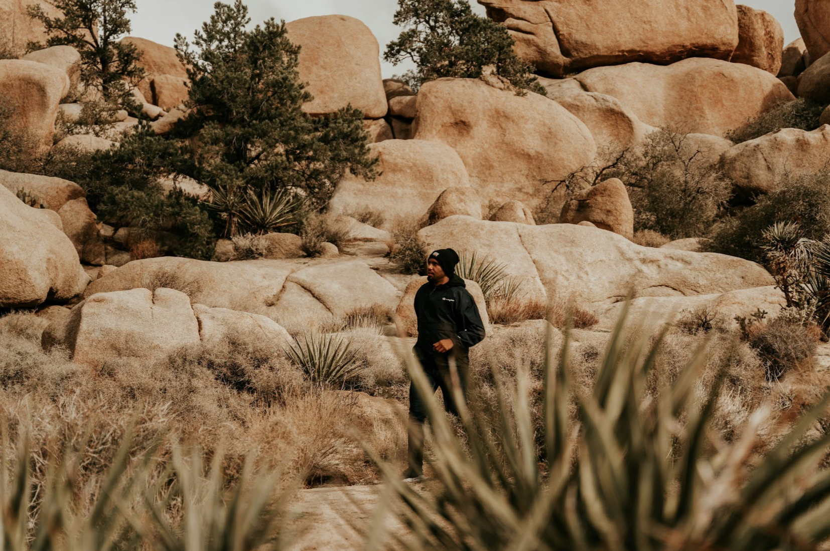 A hiker in Joshua Tree National Park, one of the SoCal Adventures by Ghost Sedan