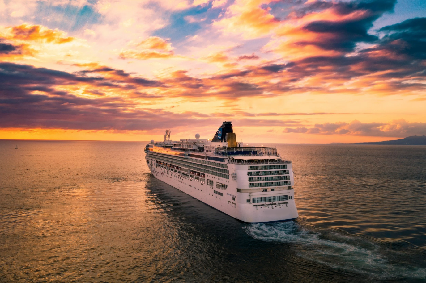 Cruise ship in the open seas at sunset