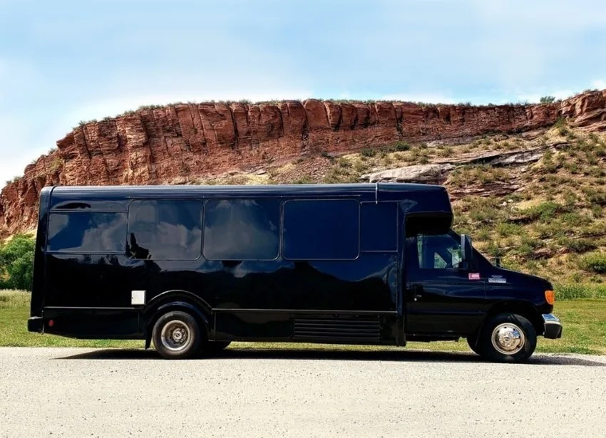 Ghost Sedan's 23 passenger Ford Shuttle Bus parked in the desert
