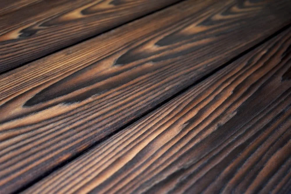 Close-up of charred and brushed wooden planks  with  visible grain patterns.