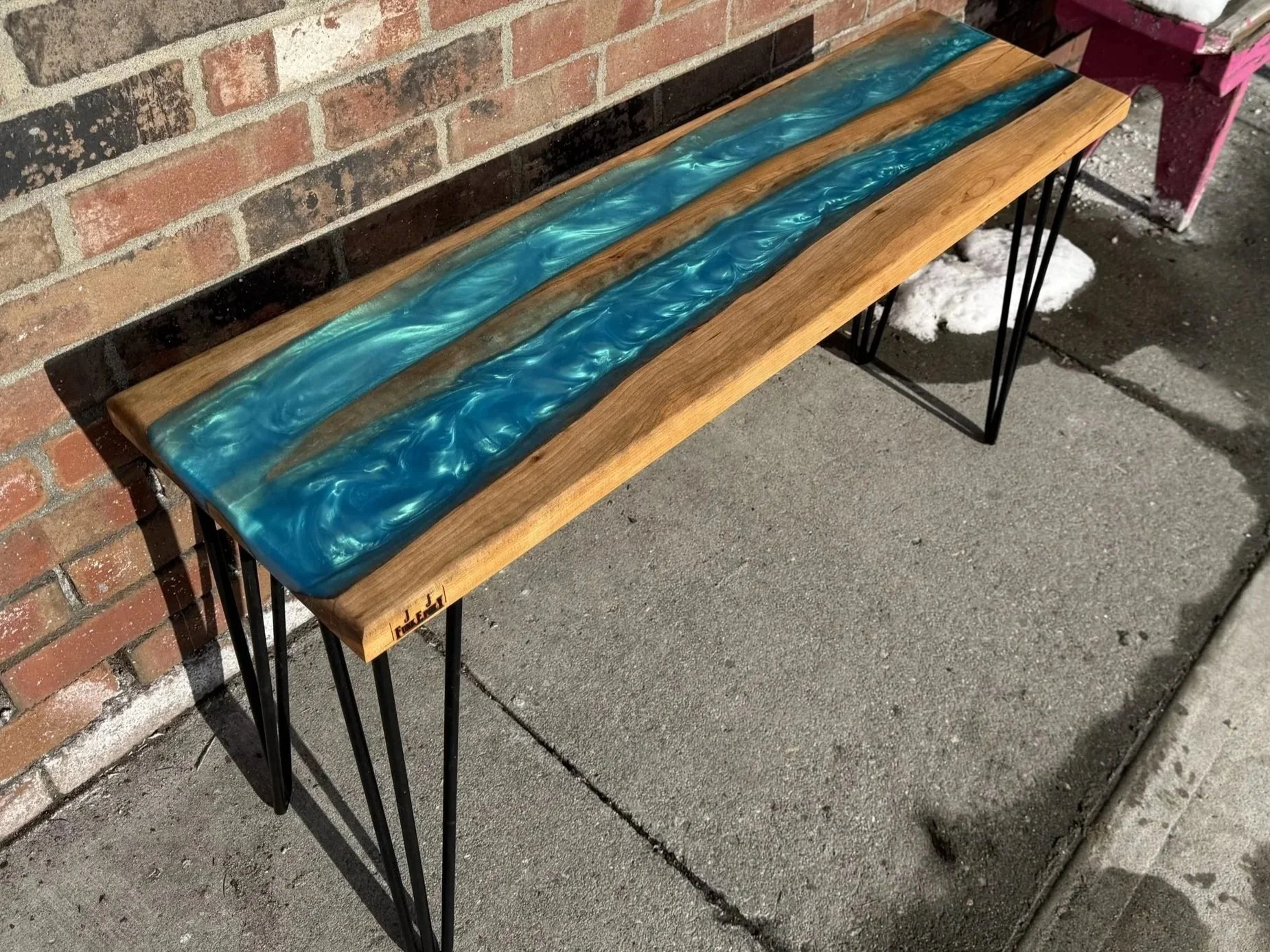 Custom, bespoke bench featuring cherry wood, two turquoise epoxy rivers, and hairpin legs.
