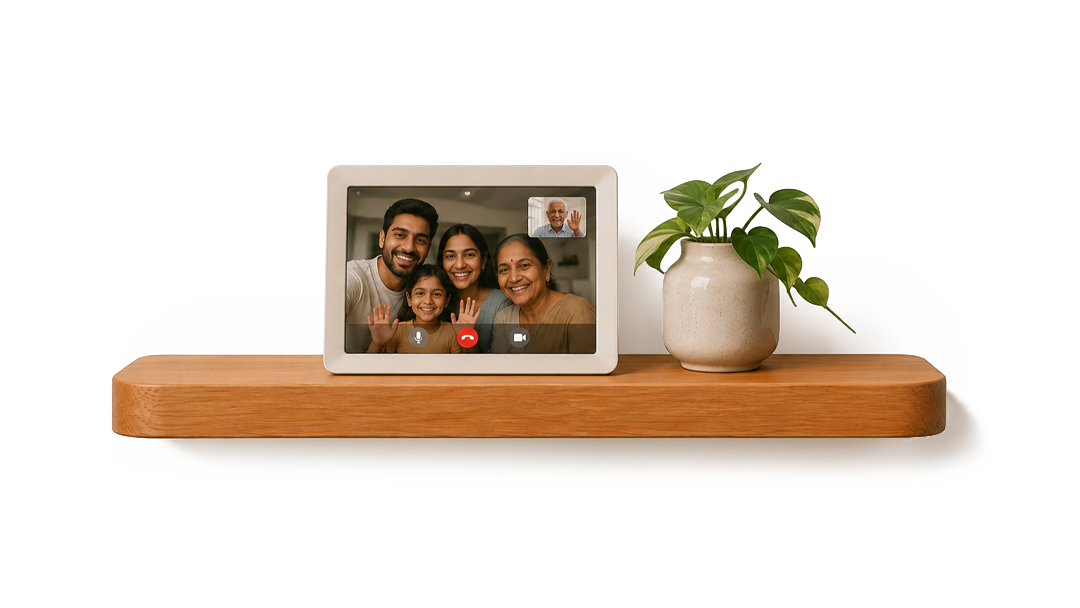 A smart home device on a wooden shelf displaying a video call with five smiling people, next to a potted green plant.