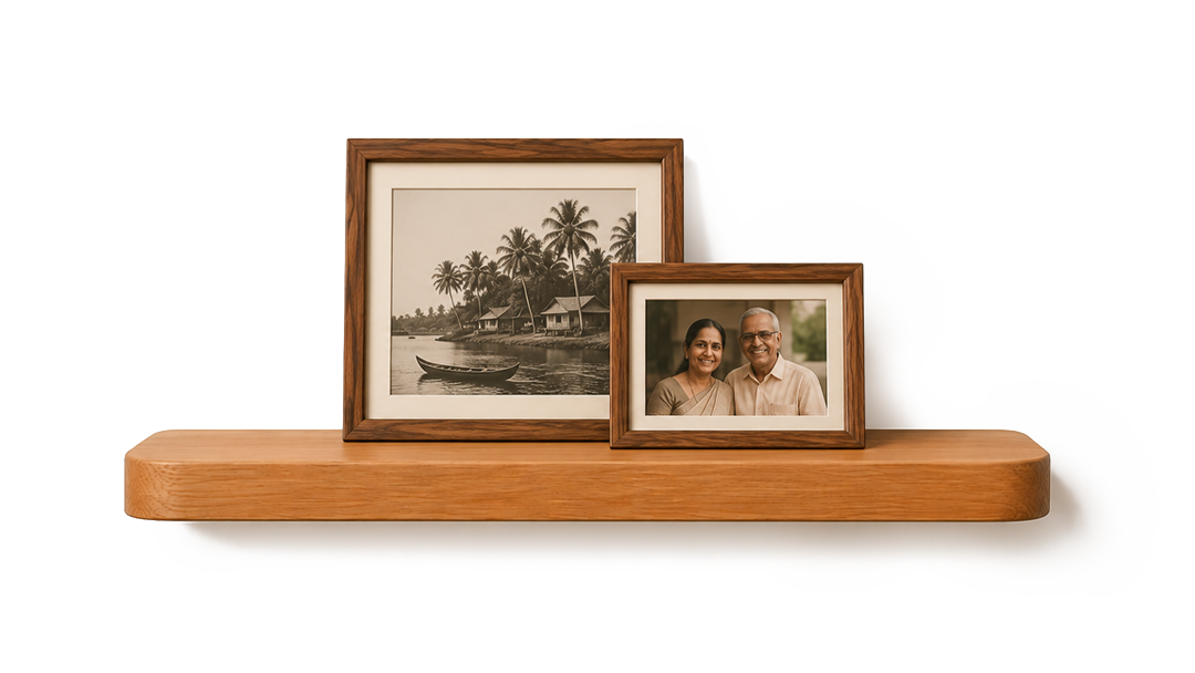 Two framed photographs on a wooden shelf, one black-and-white of a lakeside with palm trees, the other a color photo of a smiling couple.