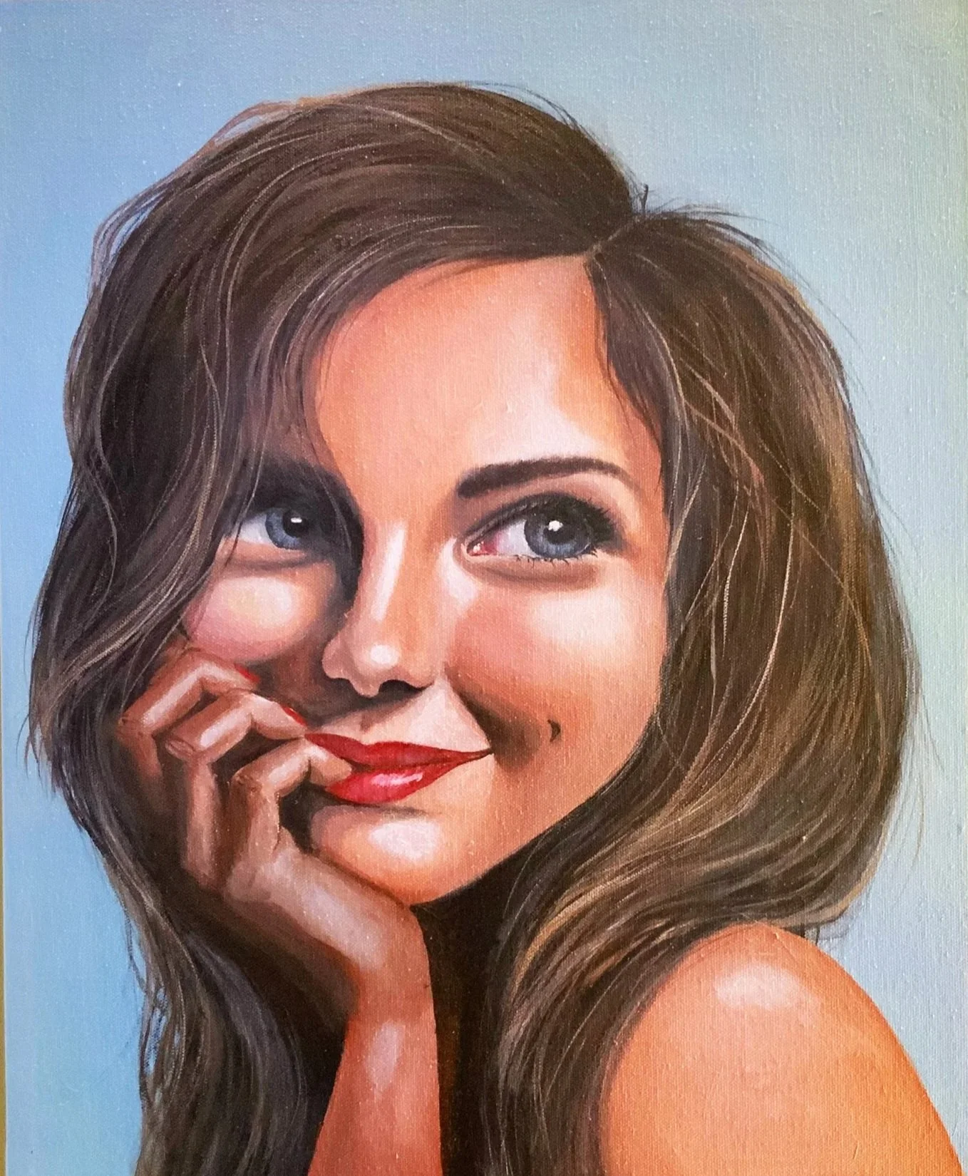 A painted portrait of a woman with long brown hair, blue eyes, and red lipstick, smiling and touching her lips with her fingers.
