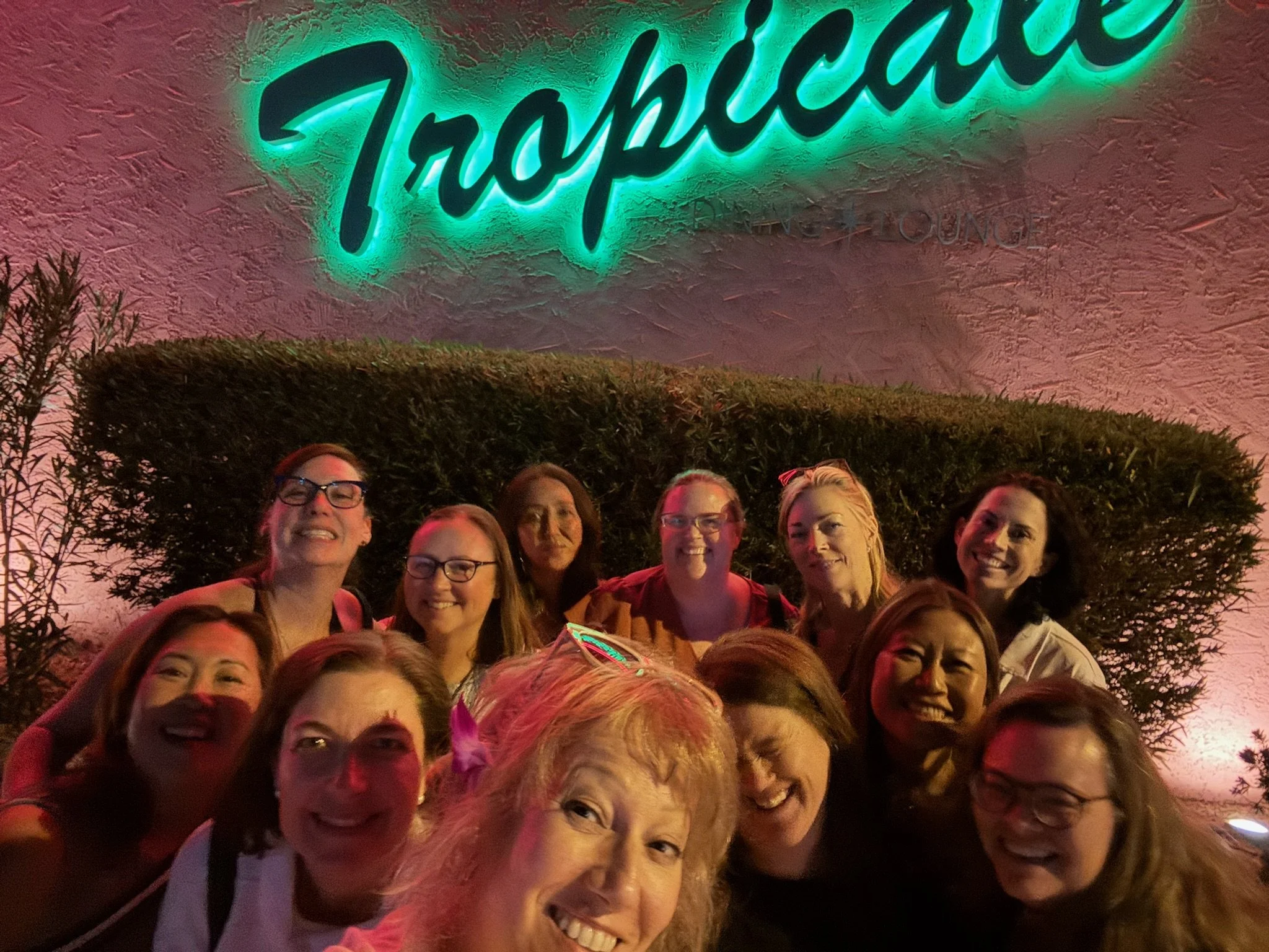 Twelve women in a selfie in front of the Tropicale in Palm Springs.