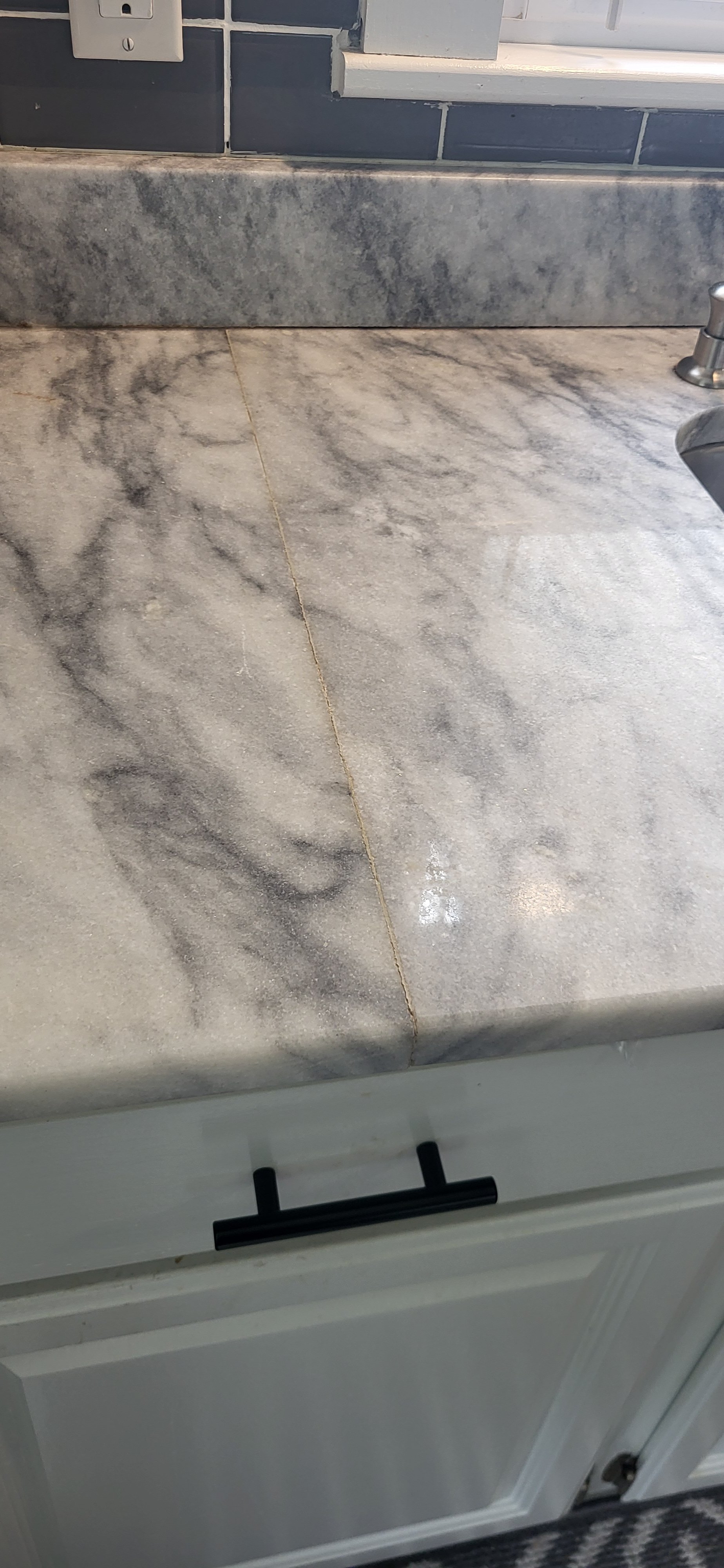This seam was loose and all the glue needed replaced. Also the marble was a little dis-colored.