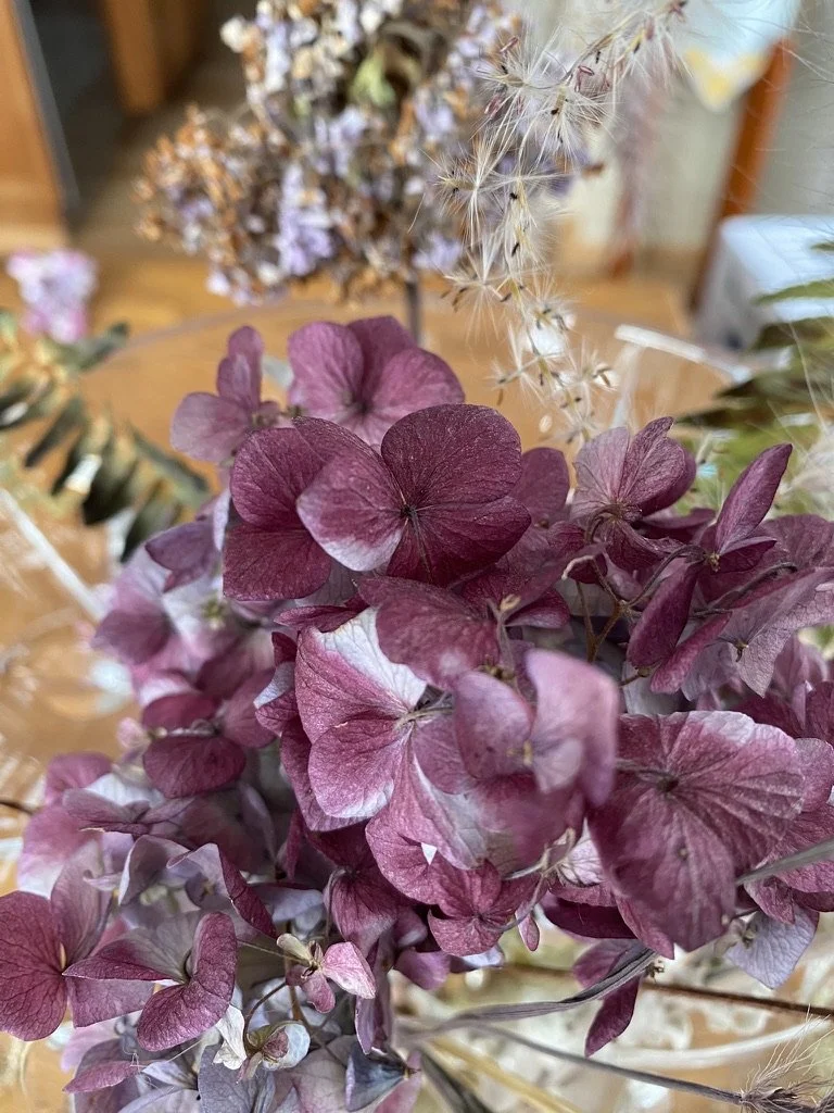 purple hydrangea blooms with seed heads on a table
