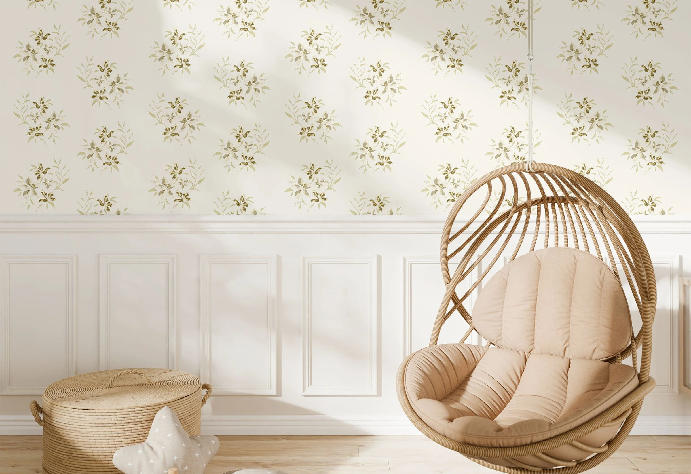 rattan hanging chair and basket in front of wall with cream woodwork below cream wallpaper with pattern of green foliage clusters