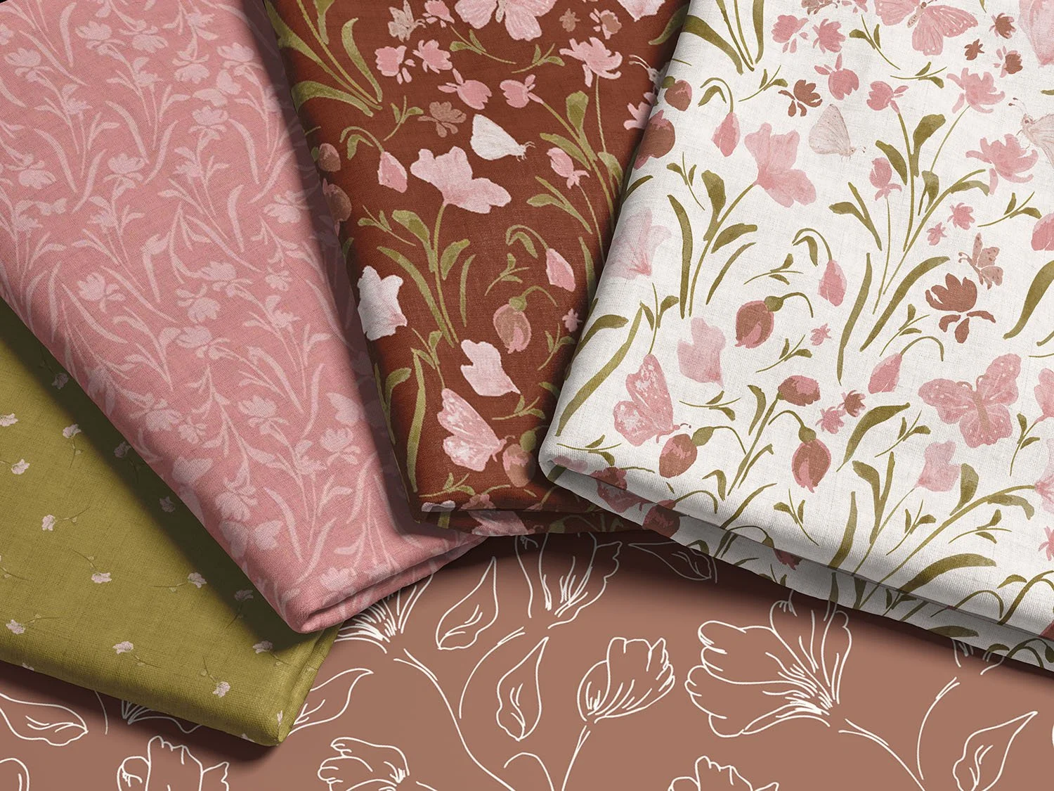 four stacked and fanned folded pieces of fabric with floral patterns in pinks, greens and browns