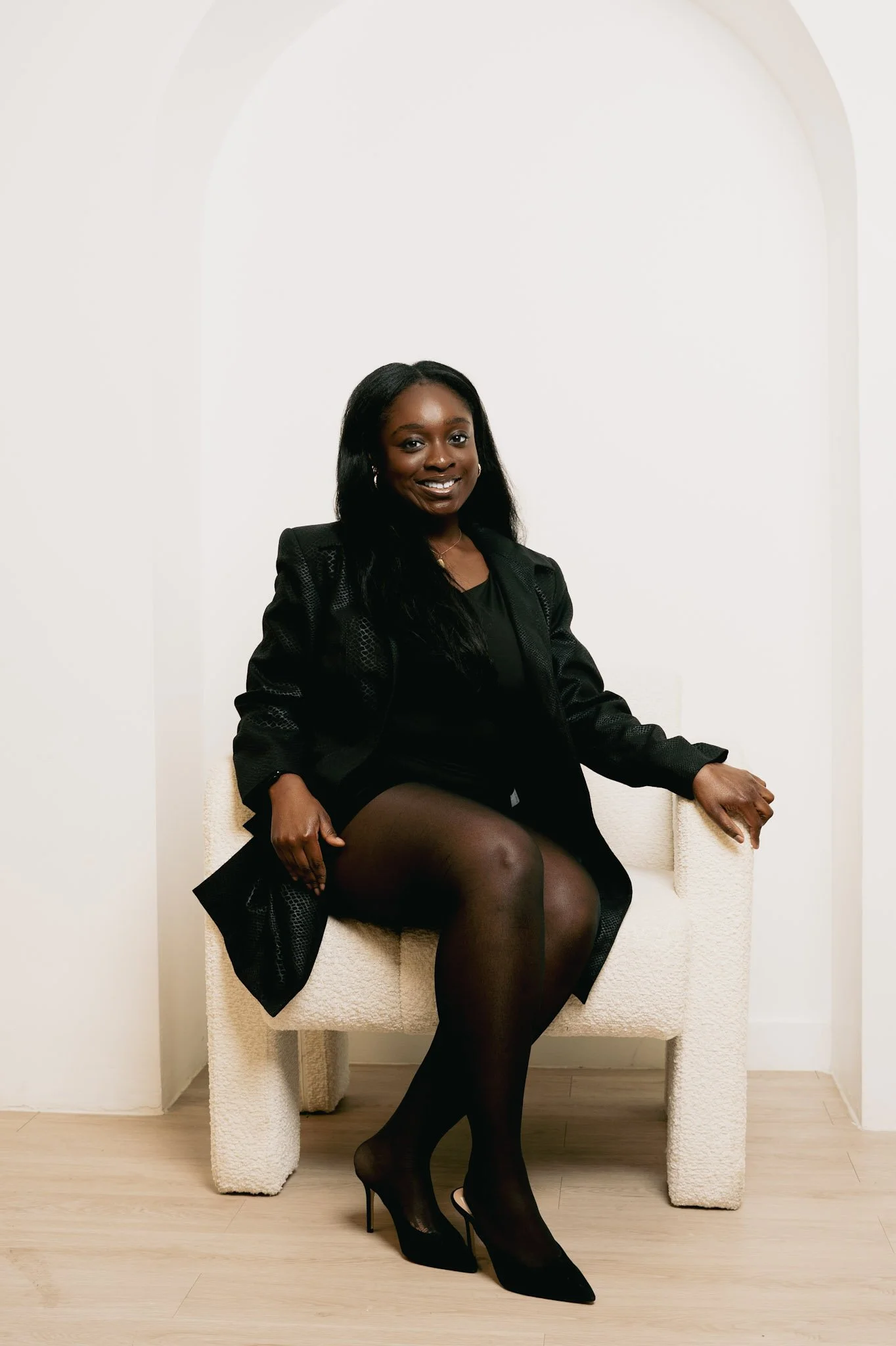 Person with braided hair wearing a brown sleeveless top in an indoor setting.