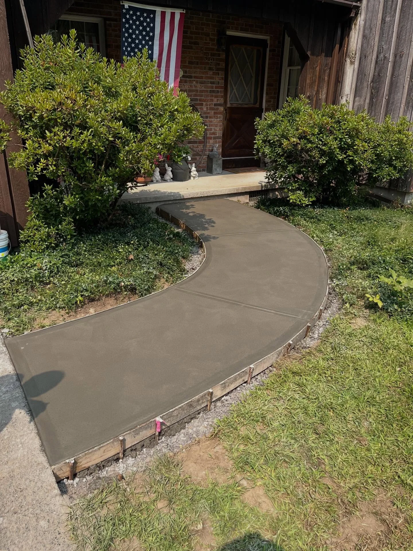 Depending on a home&rsquo;s aesthetic, a curved walkway can complement the exterior design better than a traditional straight path. For this project, we removed the deteriorated sidewalk, installed and compacted a new crusher-run base, added steel re