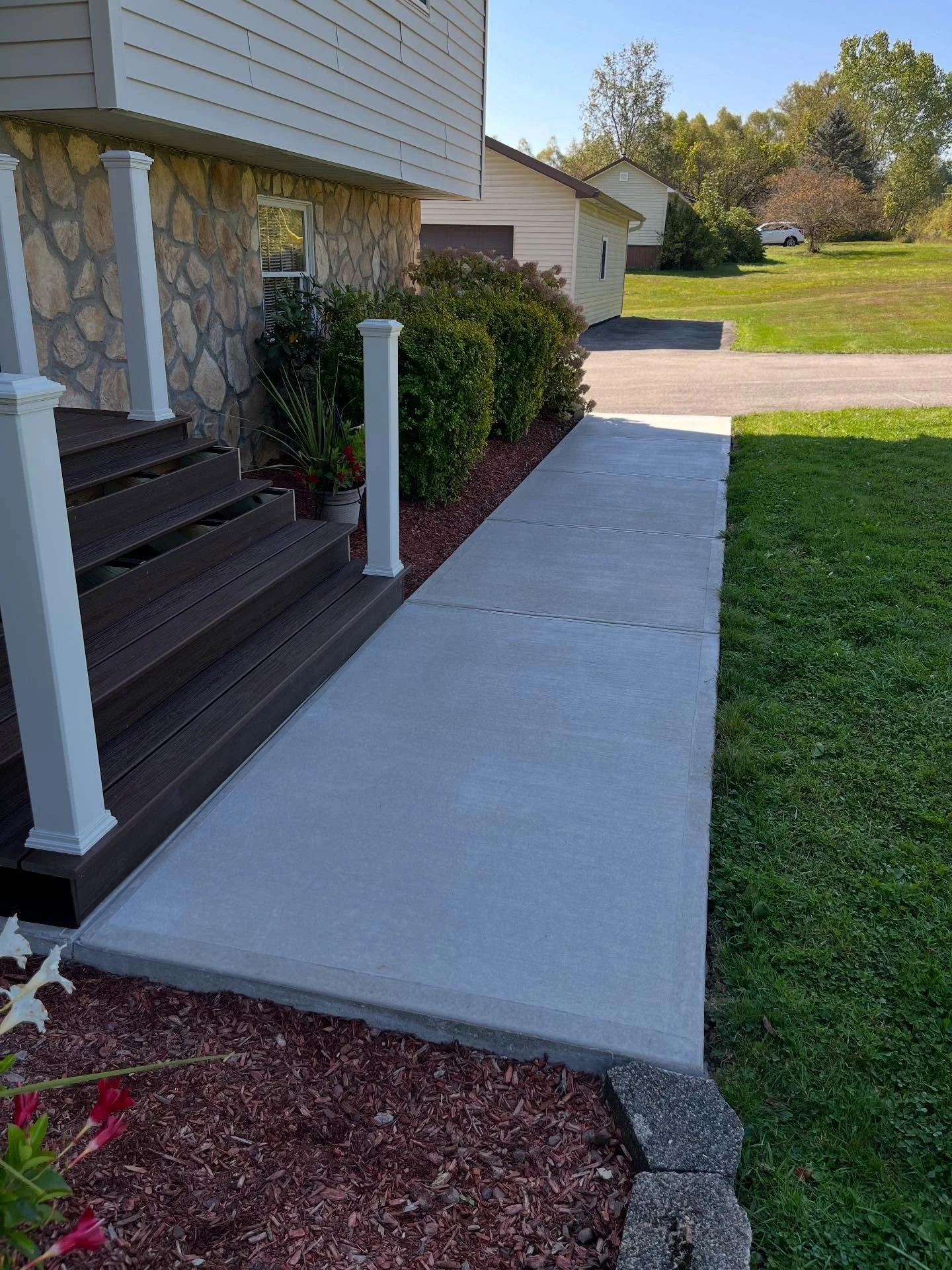 New sidewalks can significantly upgrade a home&rsquo;s curb appeal while also making seasonal maintenance easier. For this project, we excavated the existing pavers, installed and compacted a new crusher-run base, formed the walkway with steel reinfo