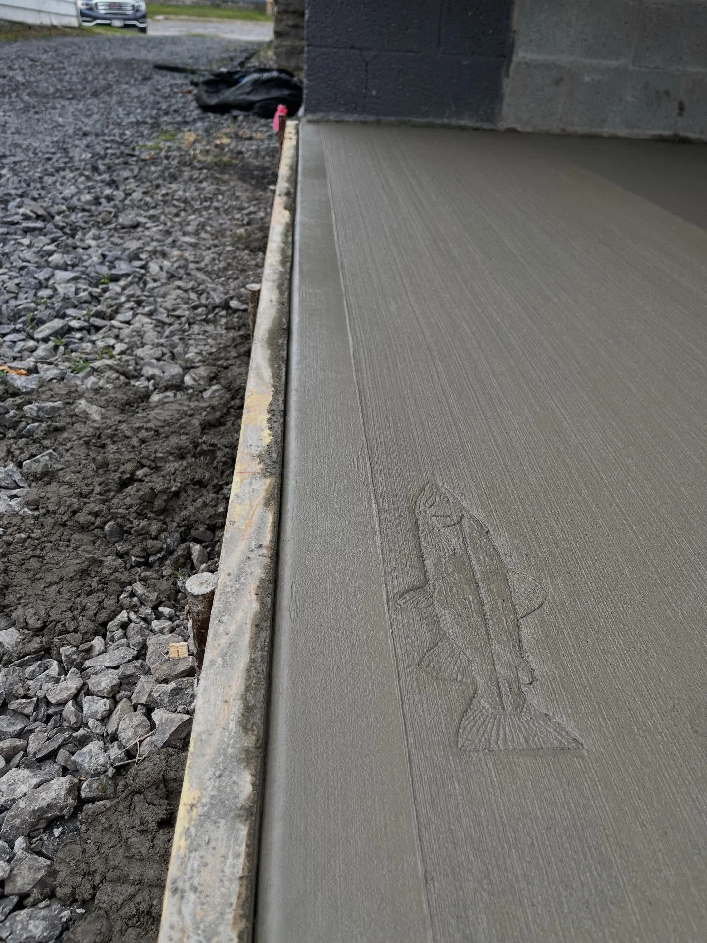 This business owner in the Adirondacks wanted to incorporate his love for the outdoors into his new concrete project. We excavated the area, formed the slab with steel reinforcement, and added a custom fish stamp to create a unique feature that will 