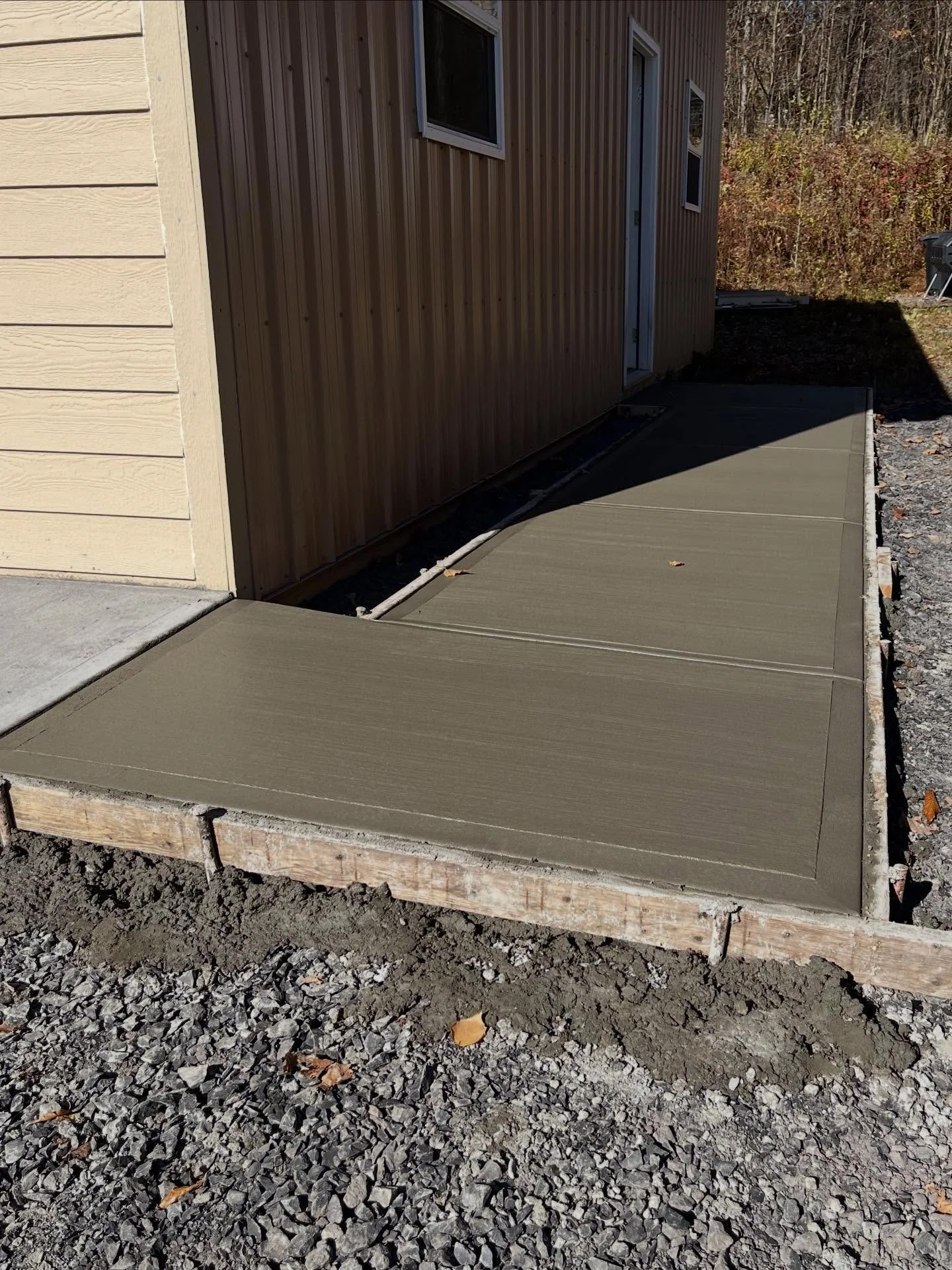 This homeowner wanted to add a garage apron, front walkway with a pad for precast stairs, garage sidewalk, and steps to connect the areas. Phase one of the project included excavating the area and installing a compacted crusher-run base. We then form
