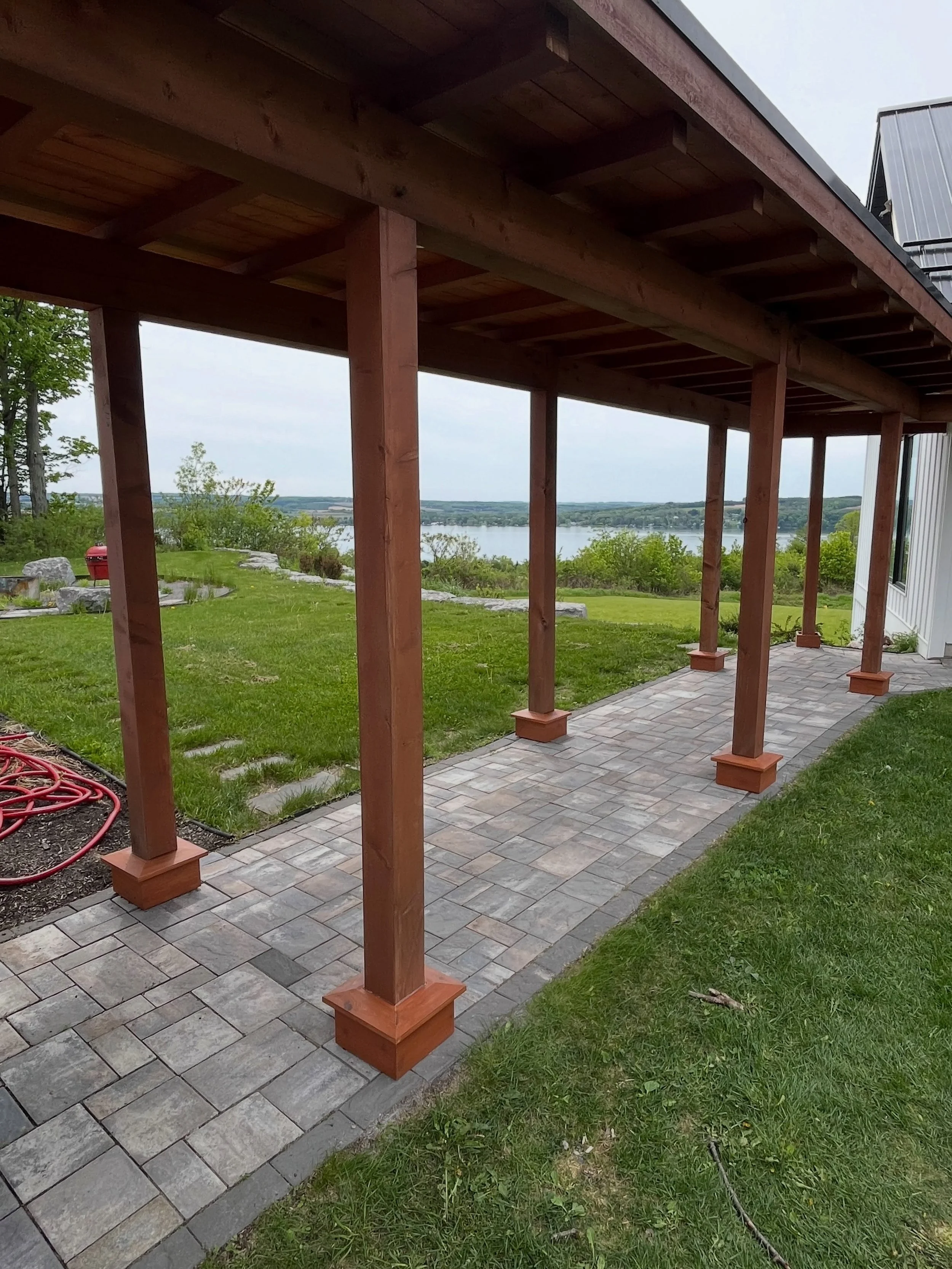 The concrete footers supporting the posts of this garage-to-house breezeway had significantly deteriorated over several winters. To address the issue, we removed all loose material, installed structural lags to improve bonding, and formed and poured 