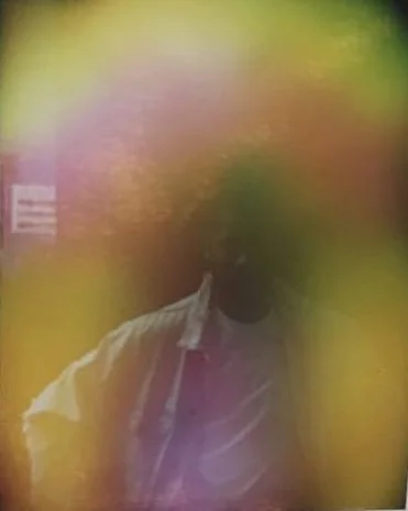 An aura image of a man named Jeffrey Bowyer Chapman in hues of yellow, orange, purple, pink, and green. Middle Frequency.