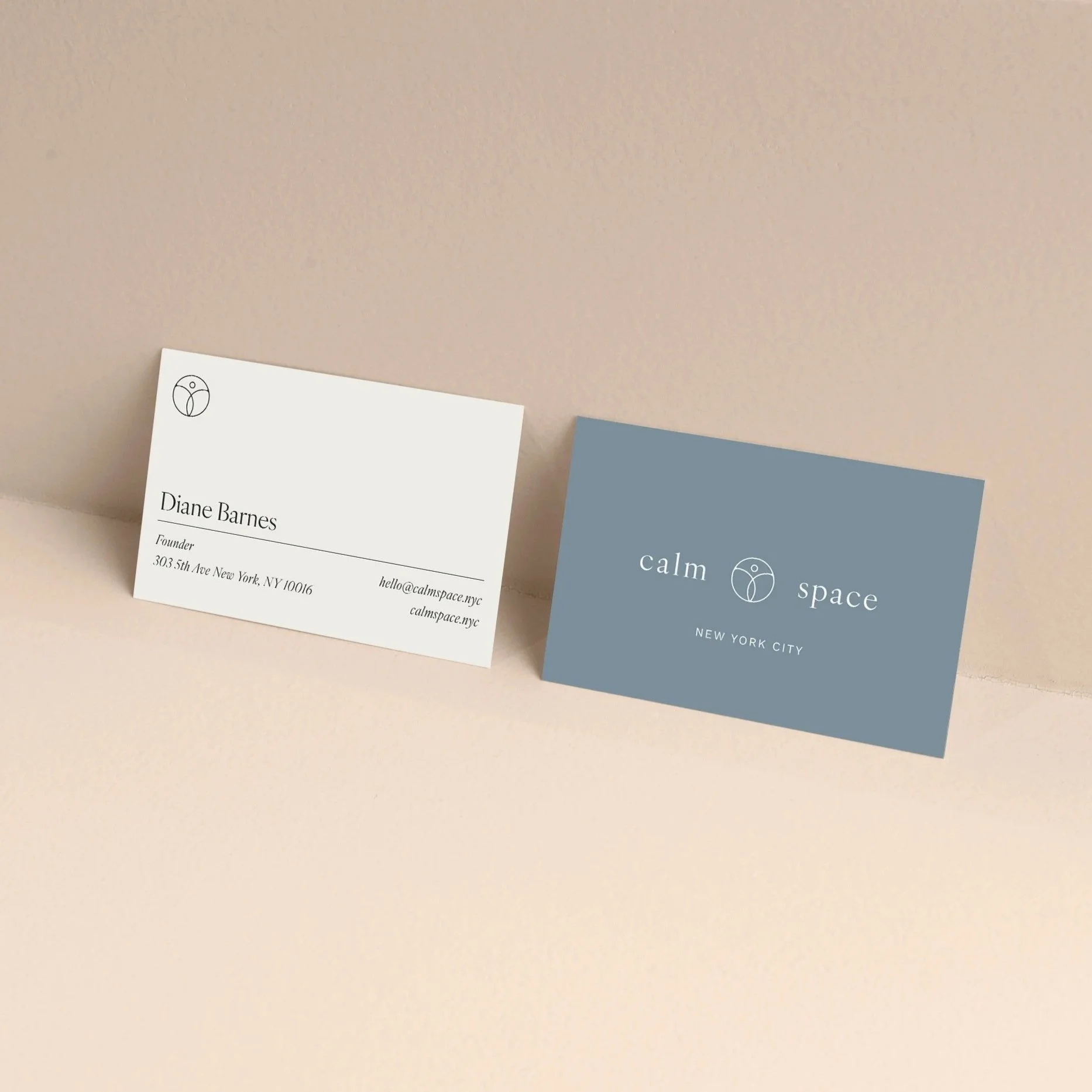 Business cards for Calm Space, featuring a white card with contact details for Diane Barnes and a blue card with the Calm Space logo and name, both on a beige background.