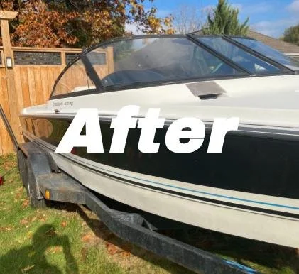 A boat on a trailer in a backyard with a wooden fence and trees in the background.