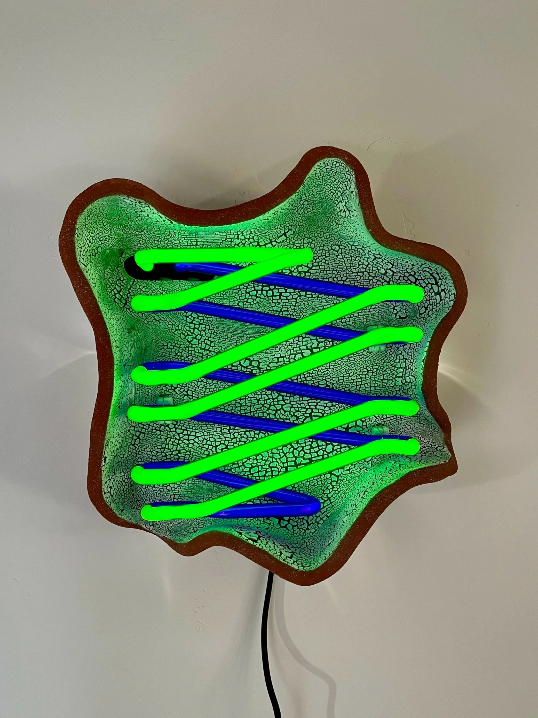 Colorful decorative glass star-shaped lamp with green and blue neon lights