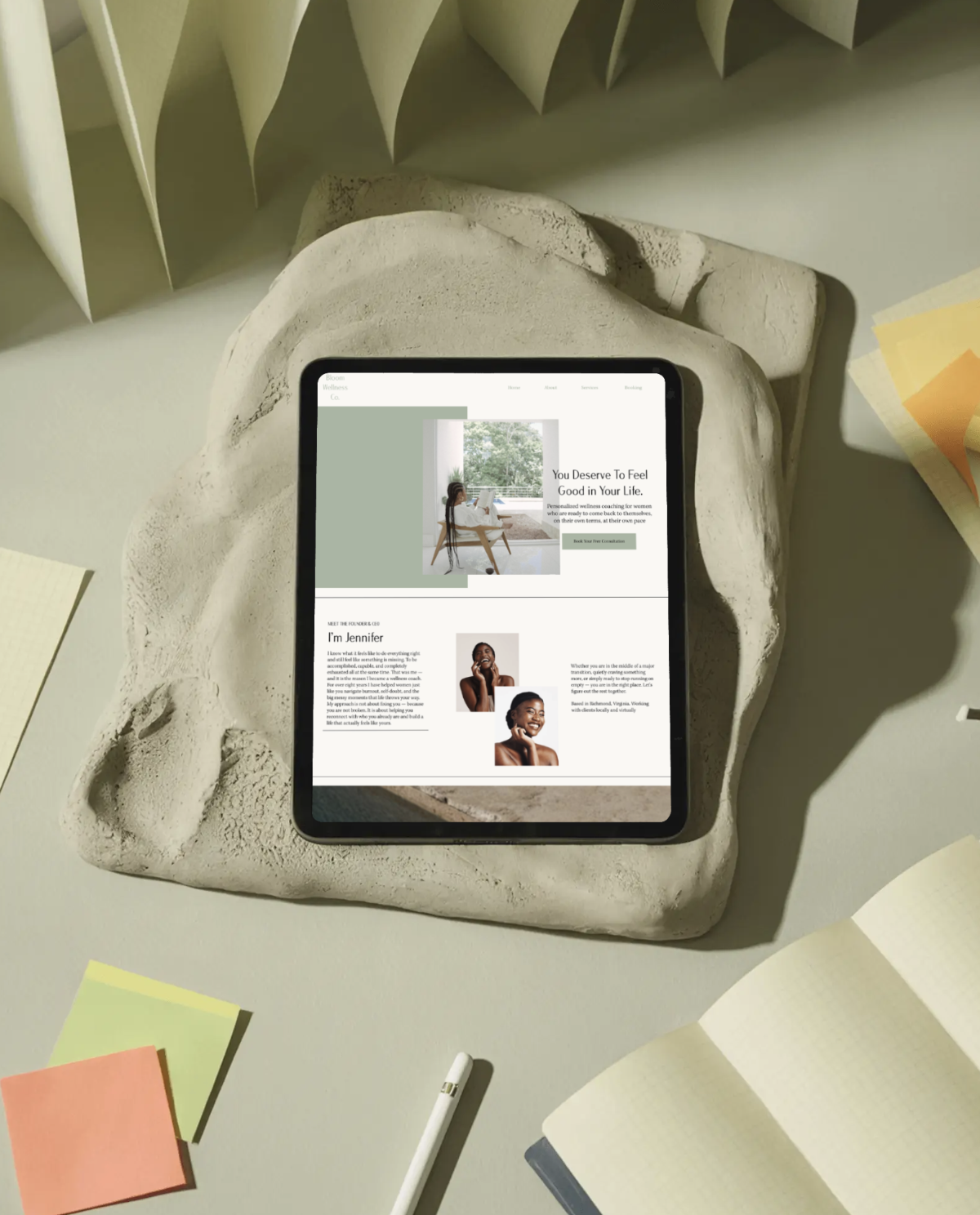 Bloom Wellness Co. women's wellness coaching website designed by Clear Canvas Design, a minority-owned web design agency in Virginia, displayed on an iPad on a wooden table.