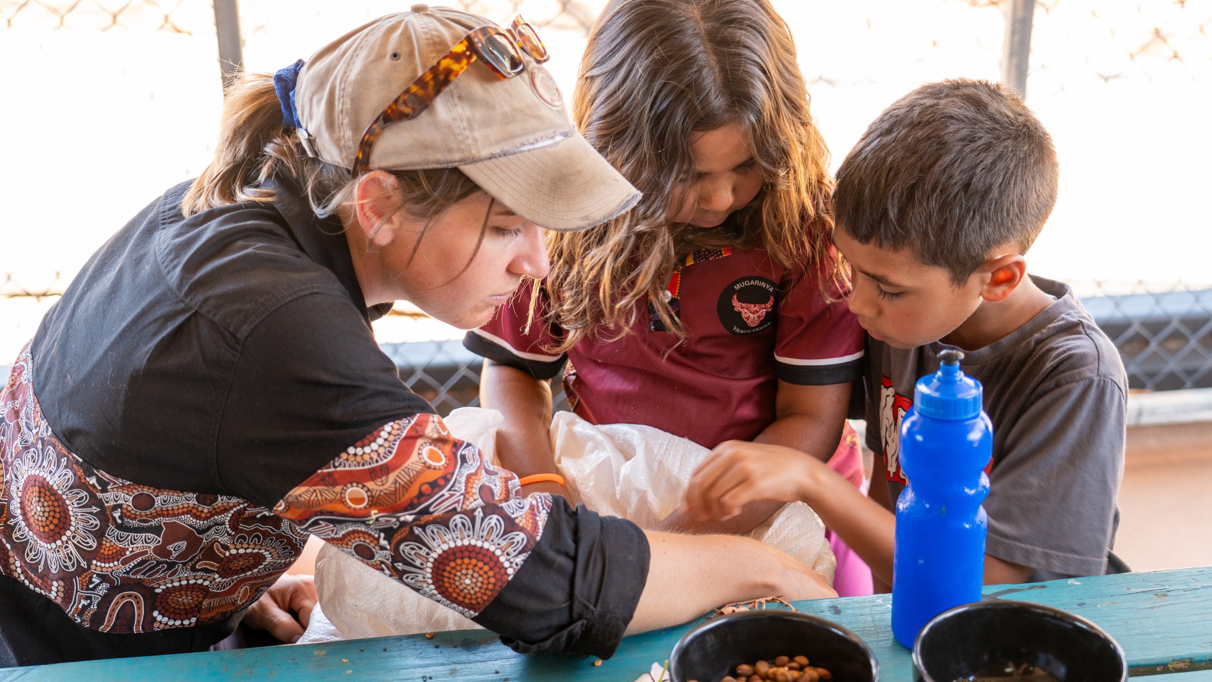 Laura from Yarnin Seeds closely examining some seed as part of a school workshop.