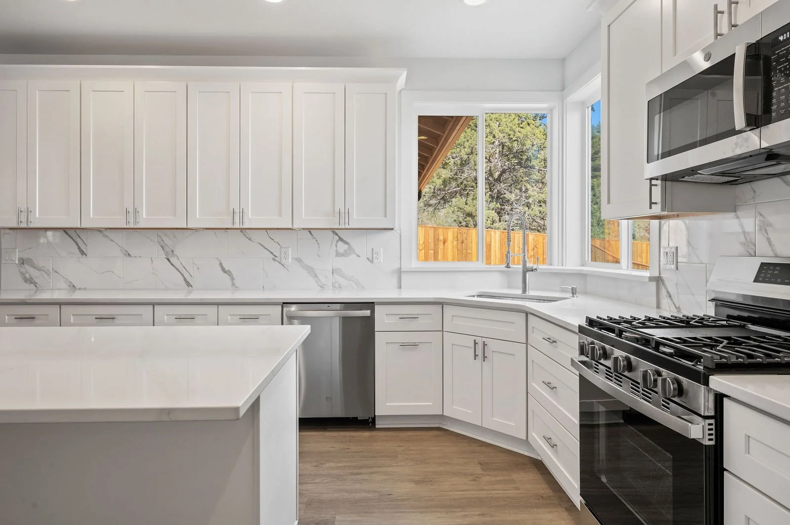Professional real estate photography and drone imagery- Interior shot of kitchen up close to range and sink. 