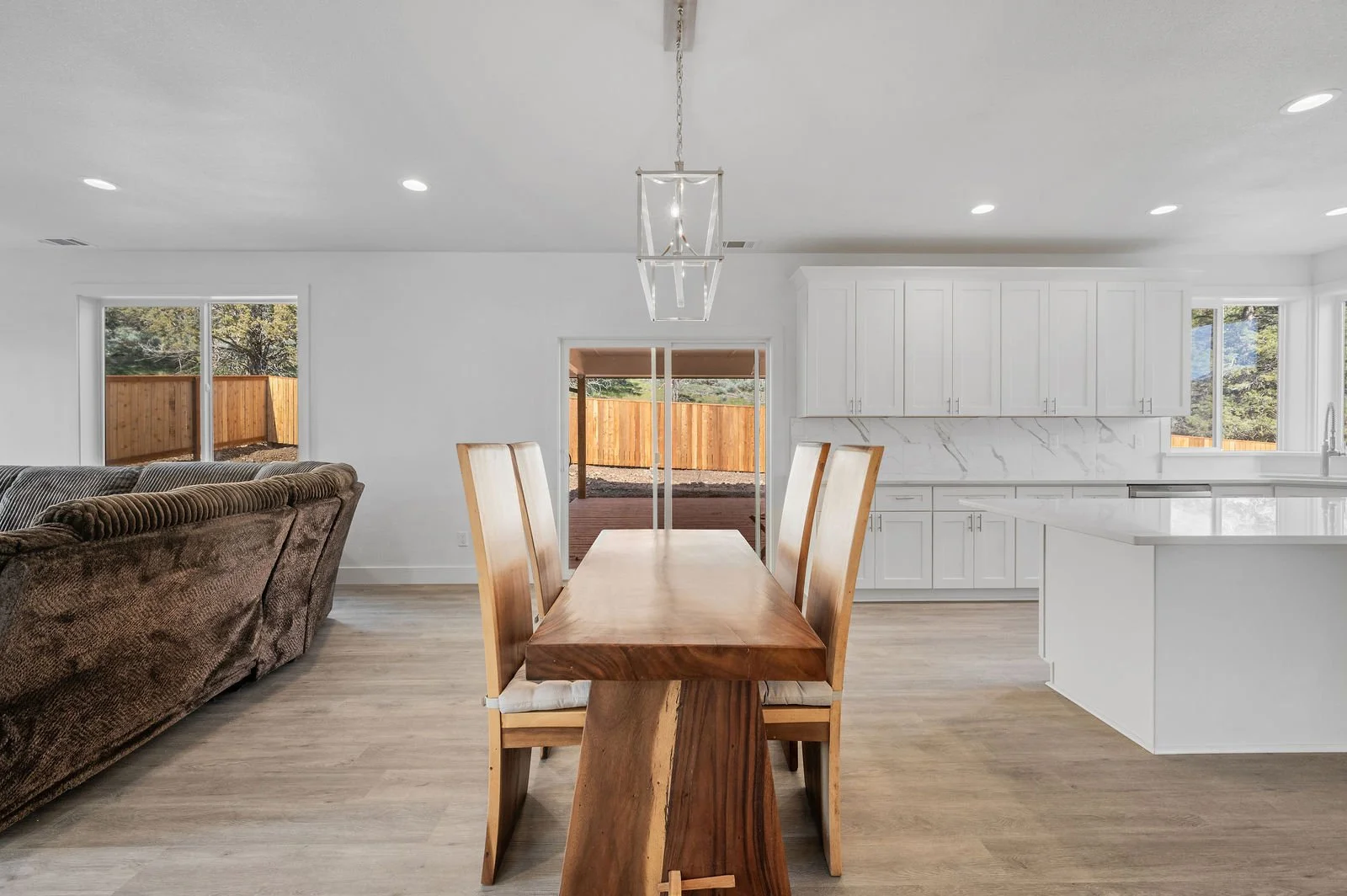 Professional real estate photography and drone imagery- Dining space with partial living and kitchen. 