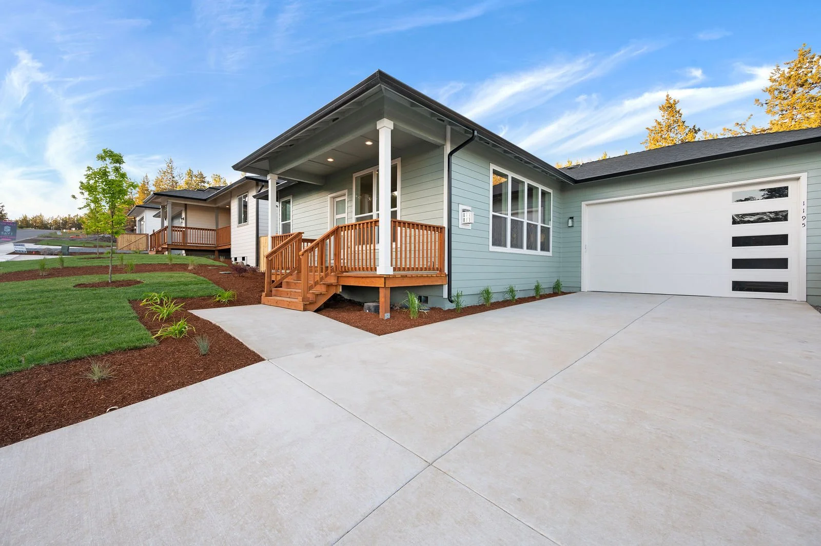 Professional real estate photography and drone imagery- Exterior of home with garage view. 