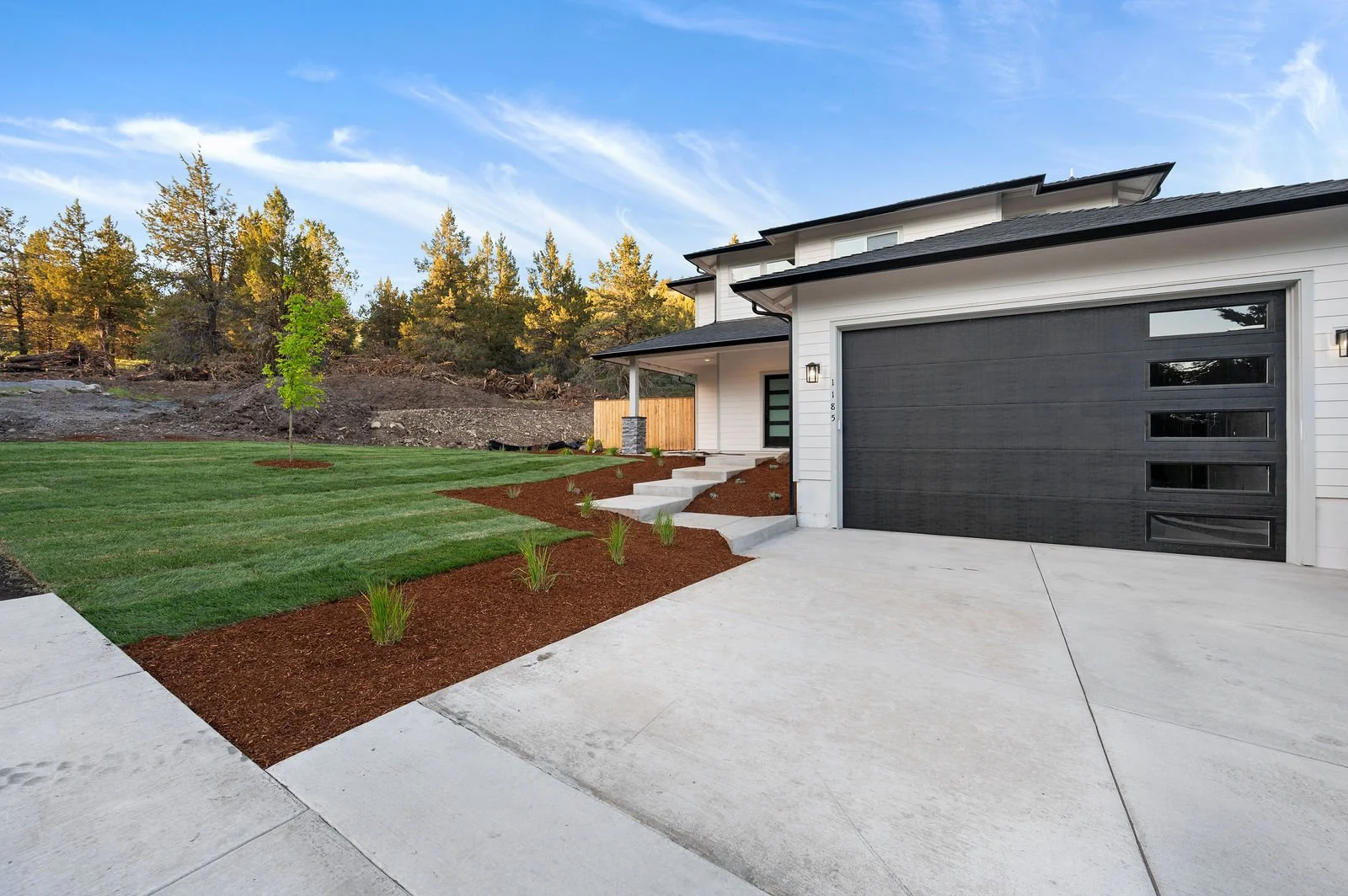 Professional real estate photography and drone imagery- Exterior of home primary view of garage. 