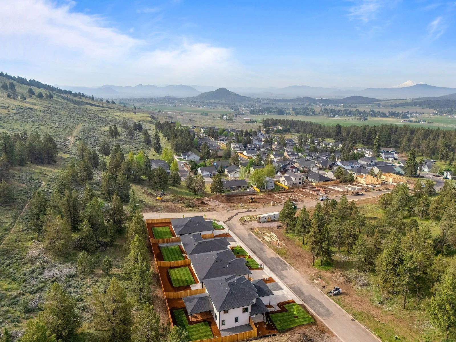 Professional real estate photography and drone imagery- Exterior drone image of four newly listed homes for sale in new development. 