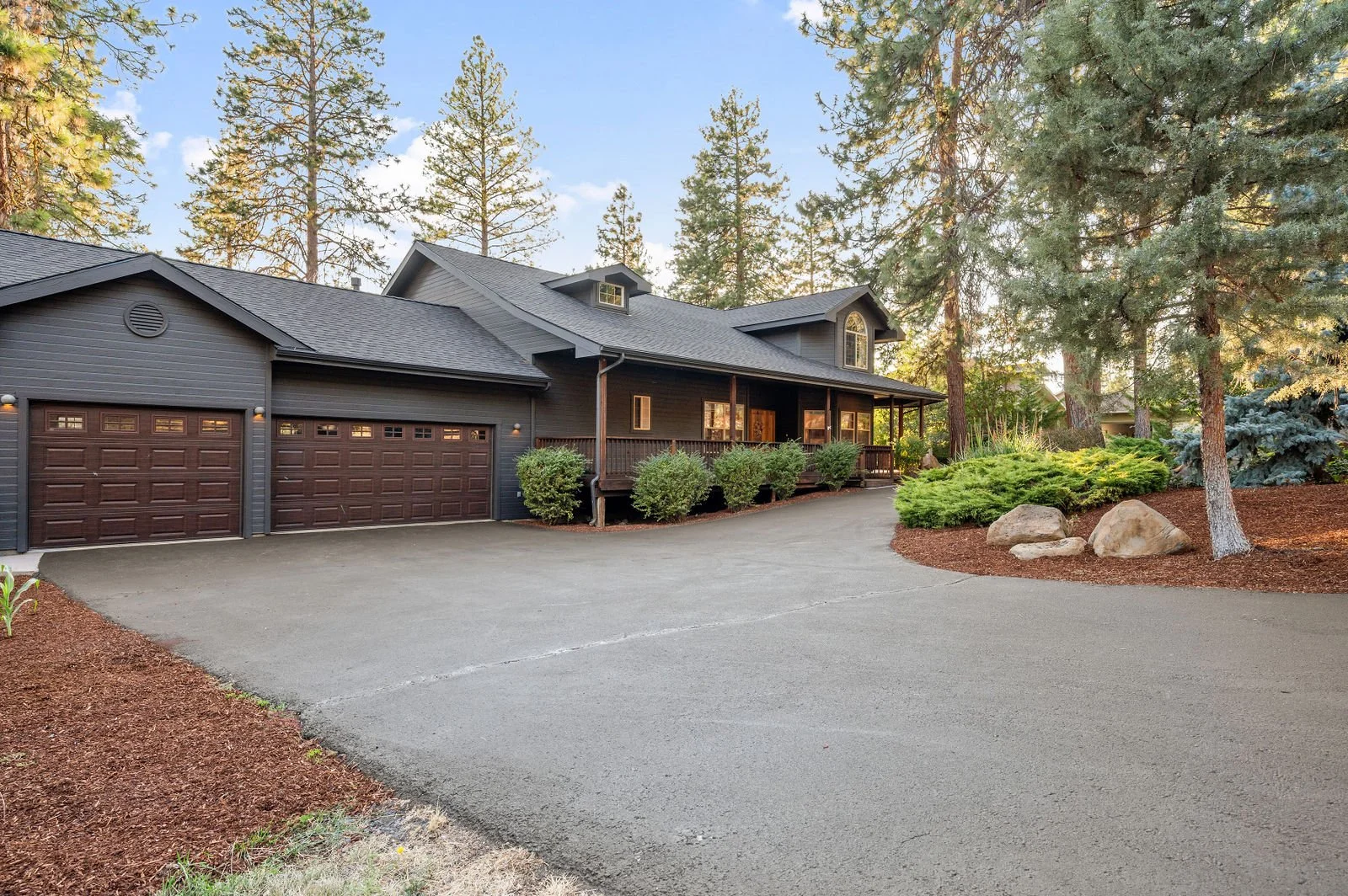 Professional real estate photograph of exterior of home with full landscape in view. 