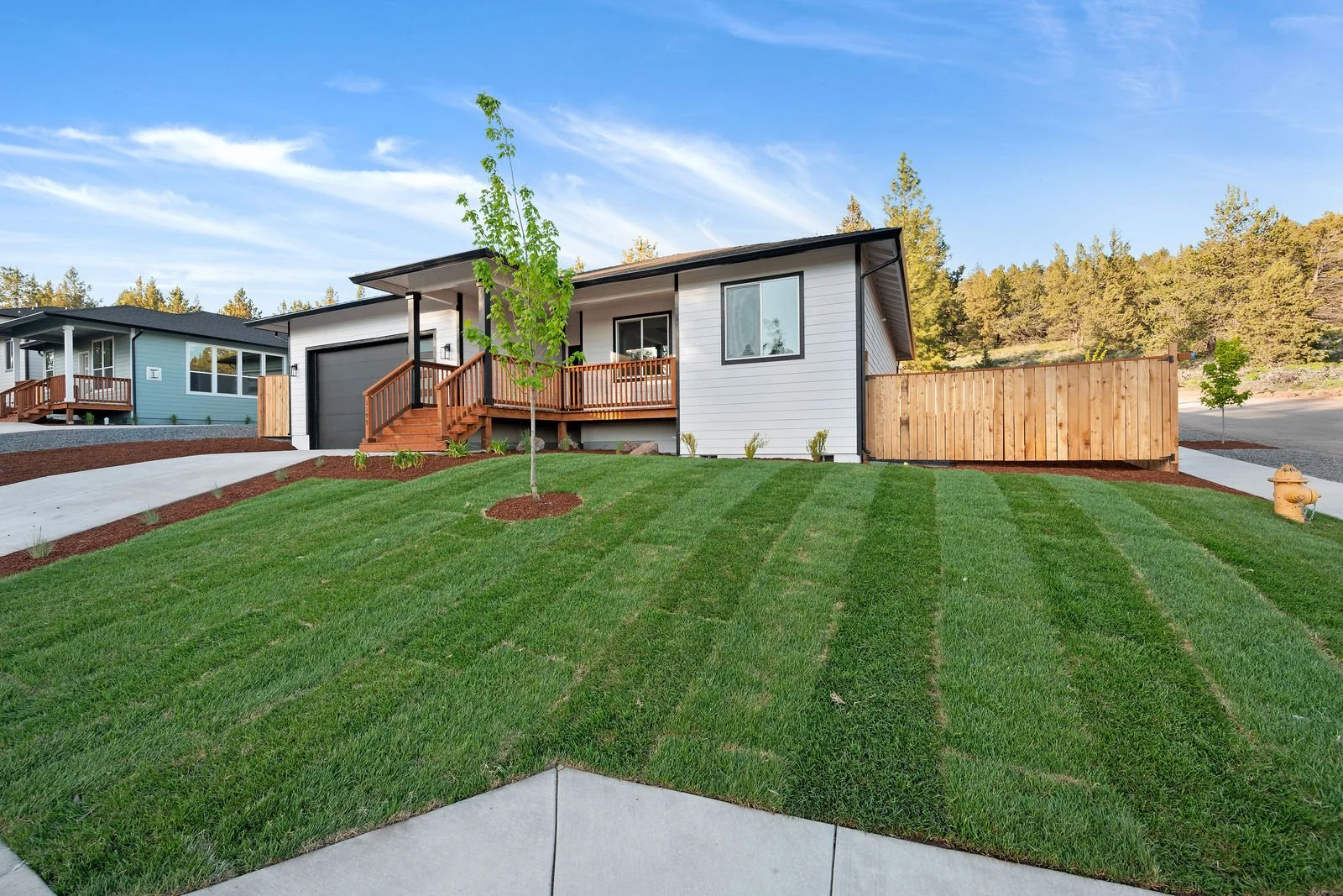 Professional real estate photography and drone imagery- Exterior of front of home with fully installed landscaping. 