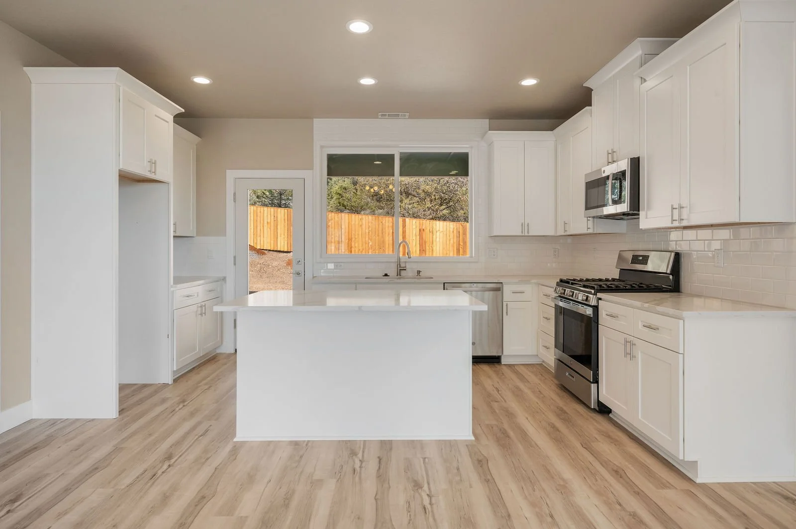 Professional real estate photography and drone imagery- Interior shot straight on of kitchen. 