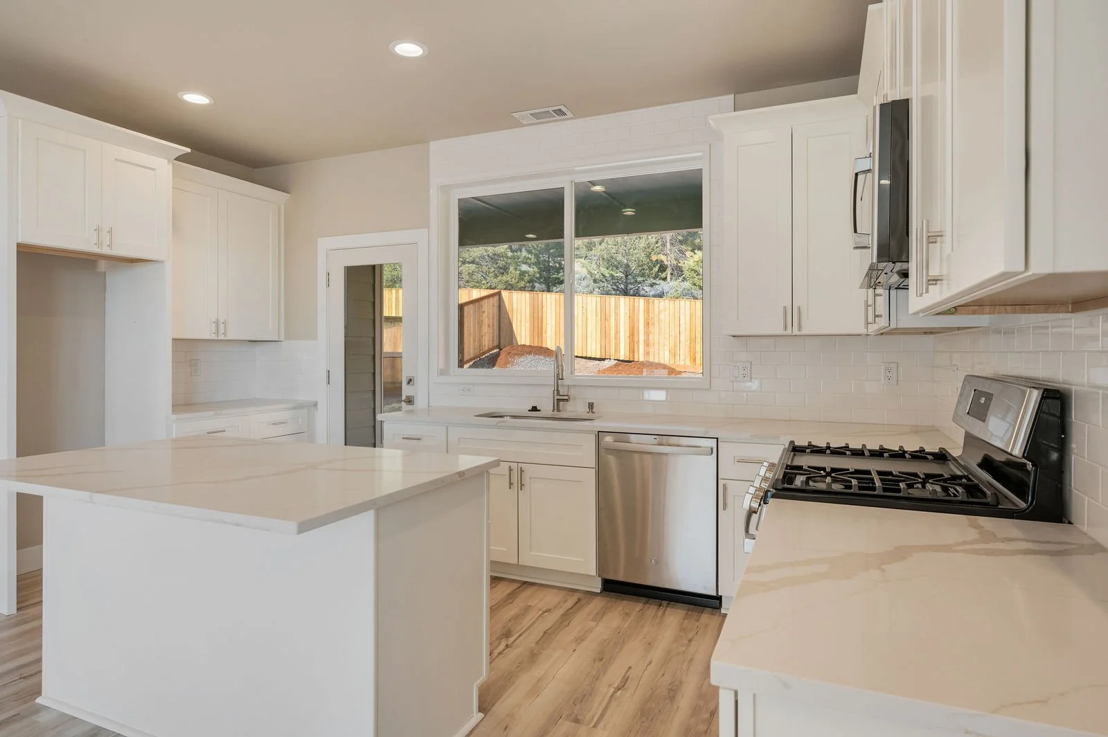 Professional real estate photography and drone imagery- Interior shot of kitchen from side perspective. 