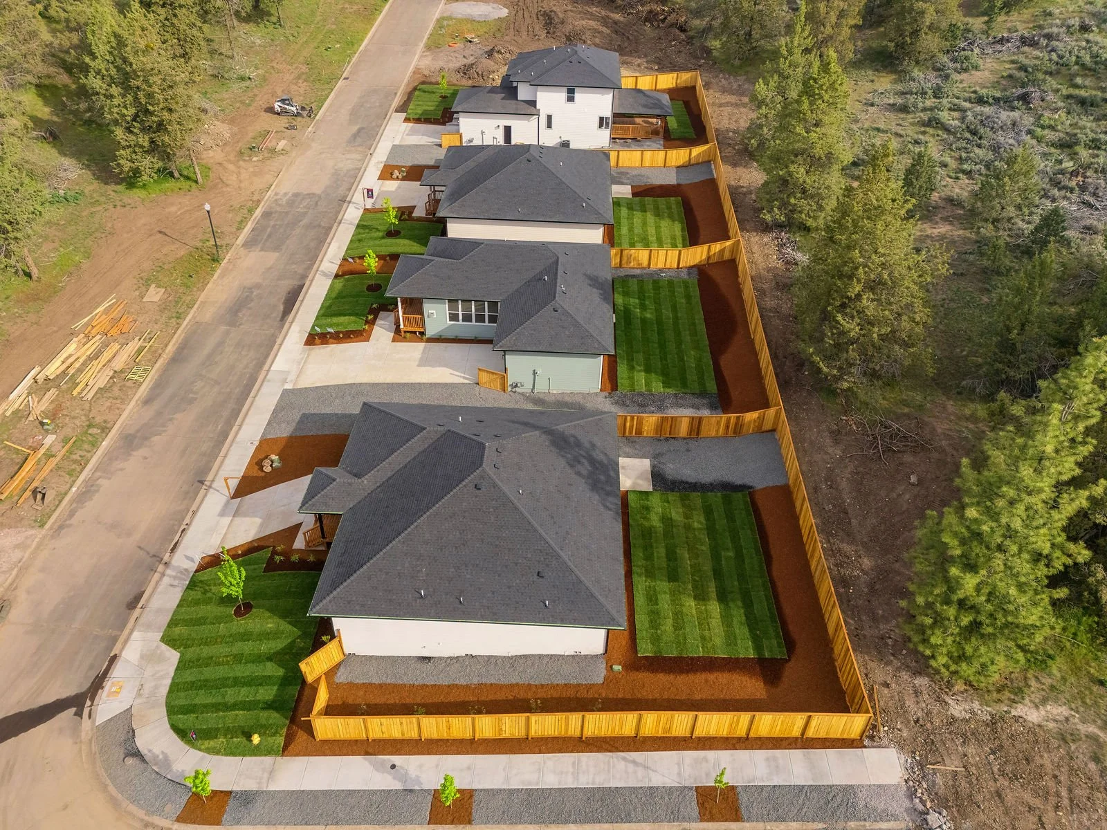 Professional real estate photography and drone imagery- Exterior drone image of four newly constructed homes in Southern Oregon. 