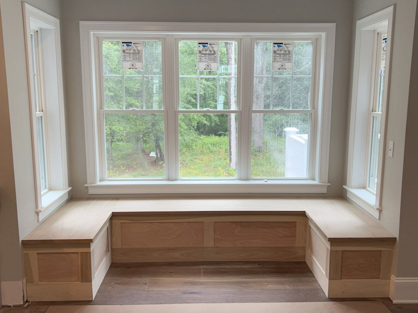 Custom window seat and built-in bench installed by Reimagined Joinery