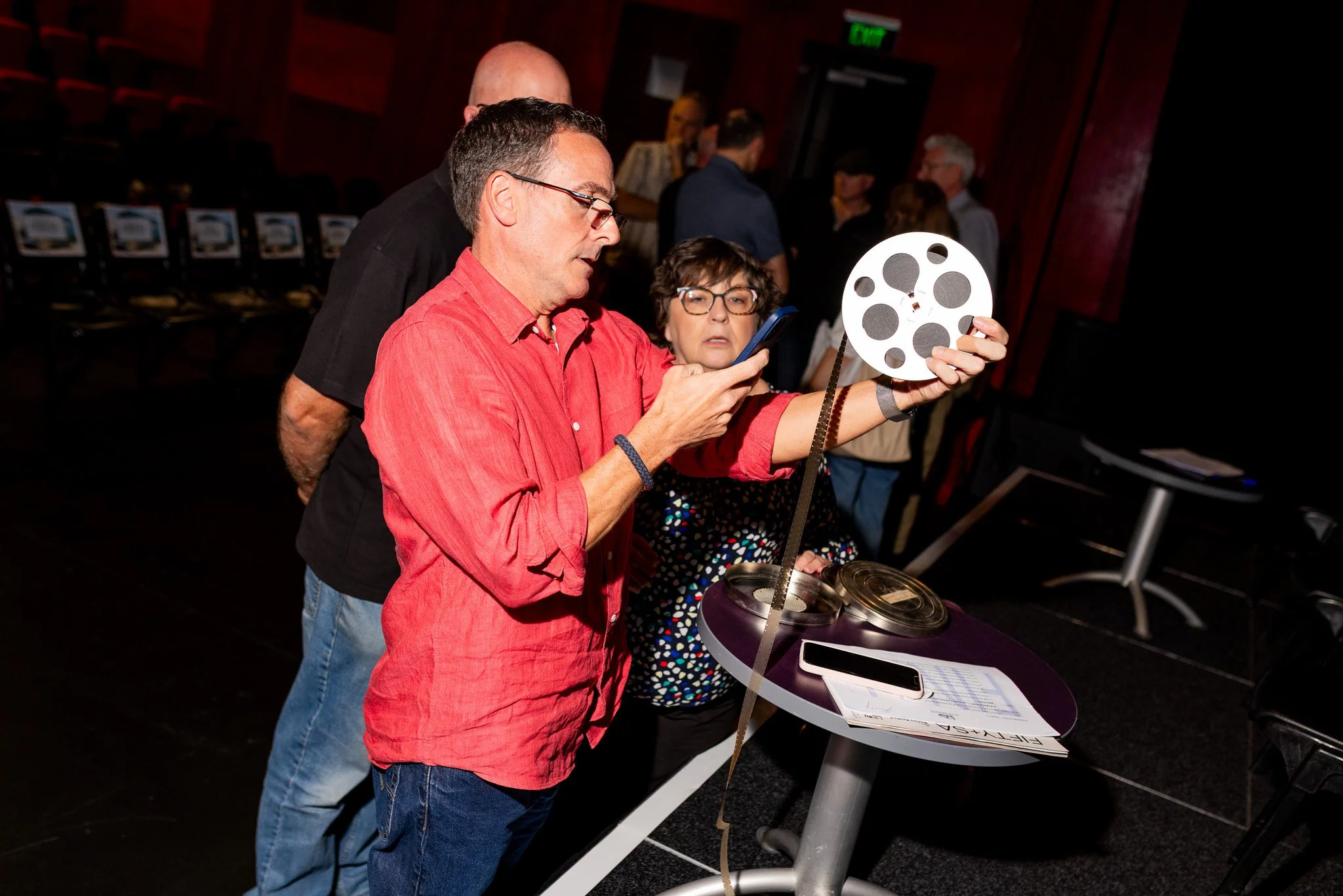 Peter Cowling (Editor) shining some light on reels of film brought along by Angela Phillips. 