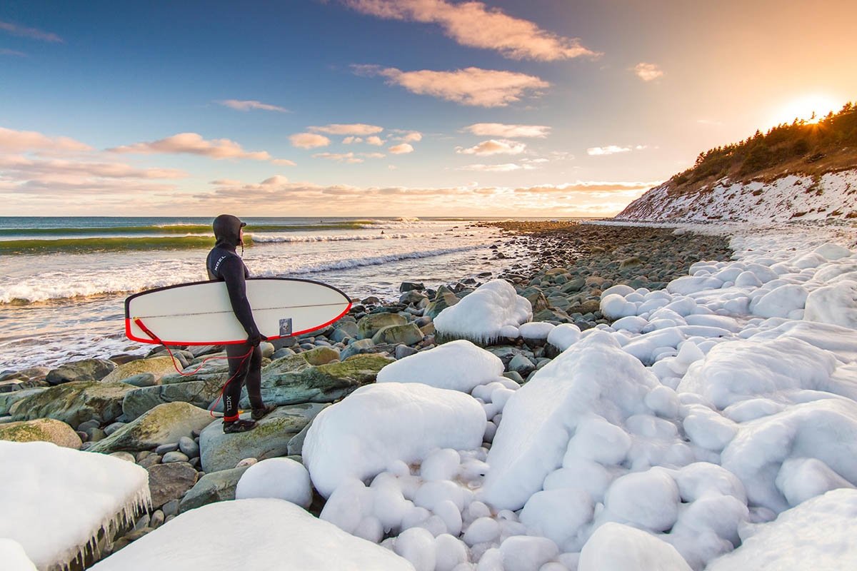 A surfer faces the shores of Lawrencetown to surf in the winter.