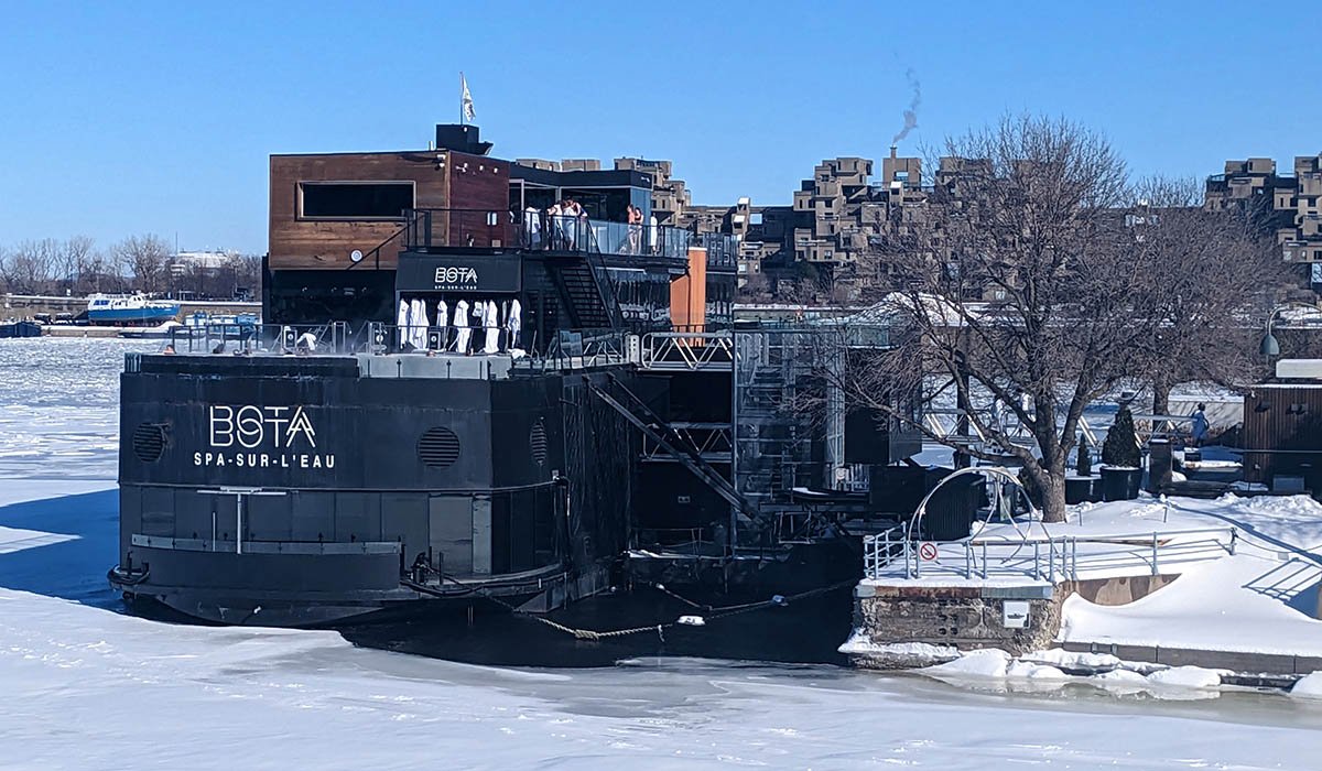 Bota Bota spa rests upon the water in Montreal during the winter.
