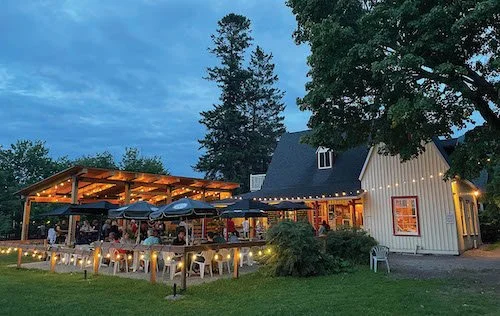 The small, outdoor patio surrounded by lights at the Tadoussac.