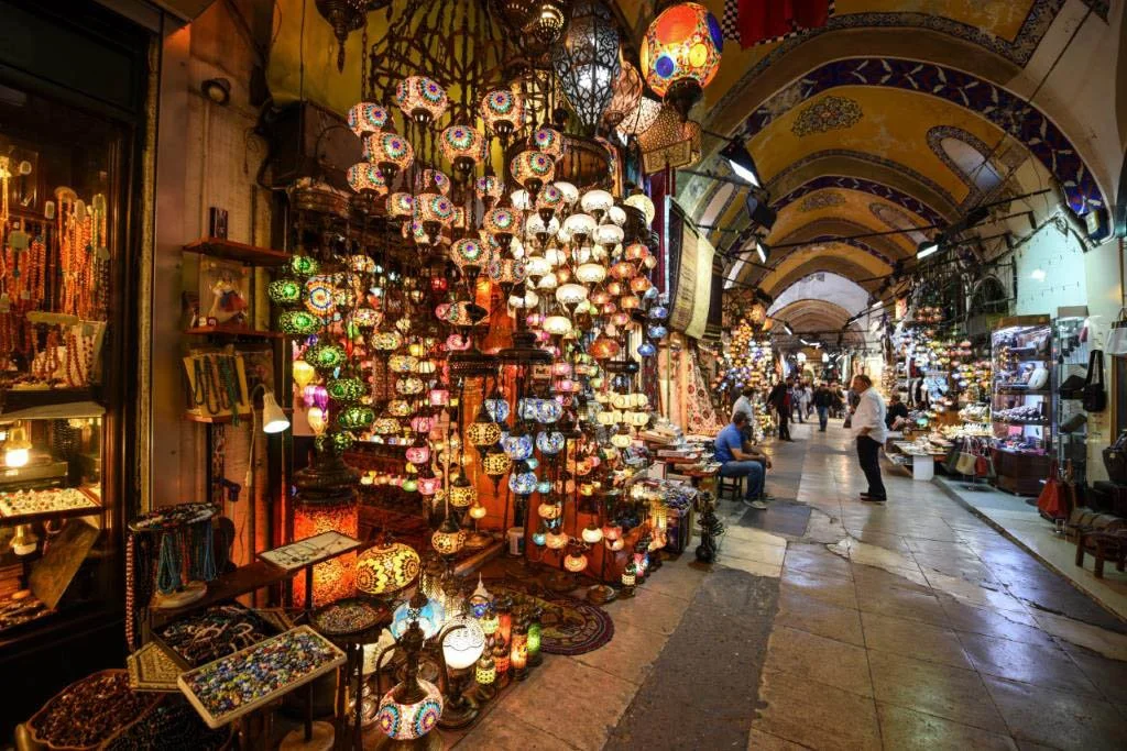 Brightly coloured lamps and murals reflect down the Grand Bazaar in Istanbul.