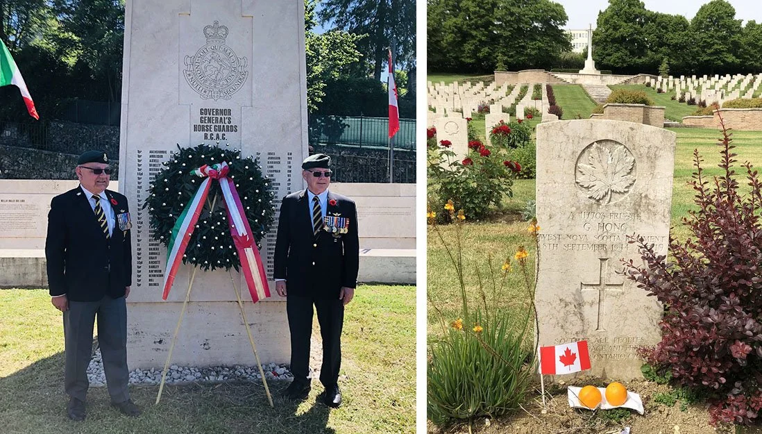 Two Canadian veterans stand in front of a monument in Aquino.