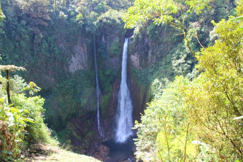 Two waterfalls crash down a cliff at Catarata Del Toro Adventures.