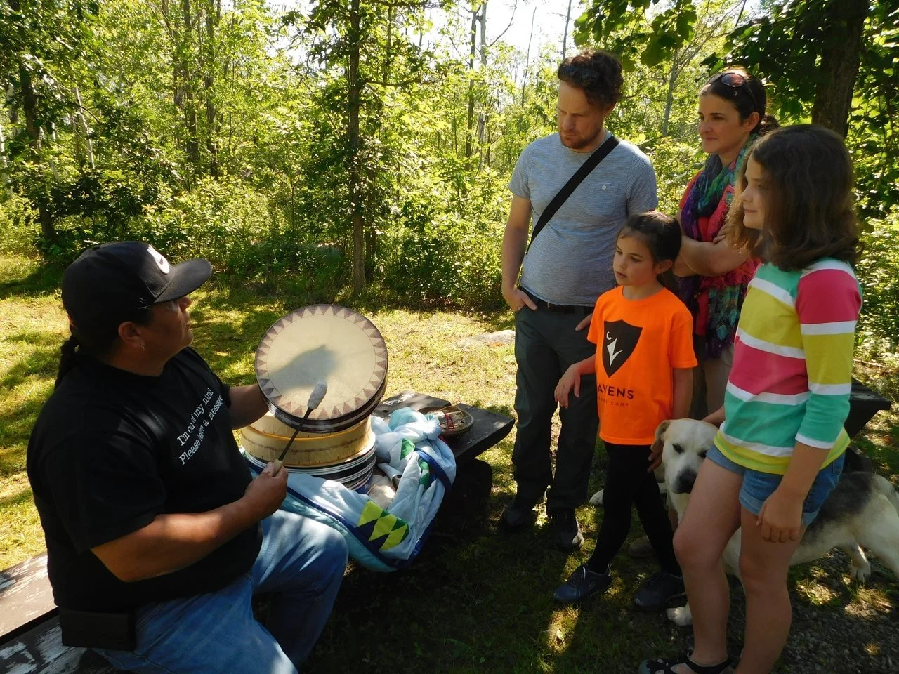 A group of visitors enjoy the culture and traditions of the Anishinabek people with Tourism Wiikwemkoong.
