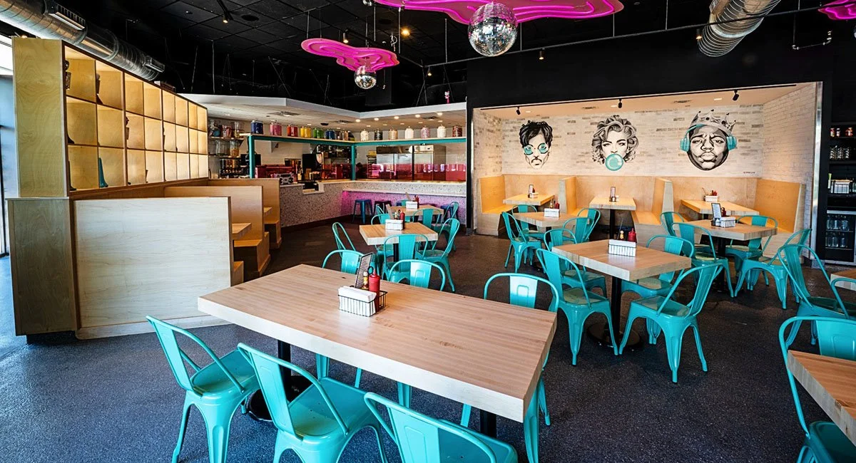 Face murals and blue chairs at Jojo’s ShakeBAR.