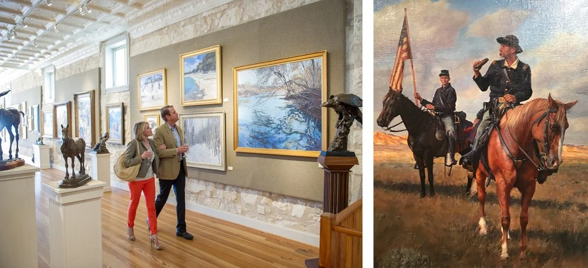 A couple glances up at the portraits at The Insight Gallery in Fredericksburg, Texas.