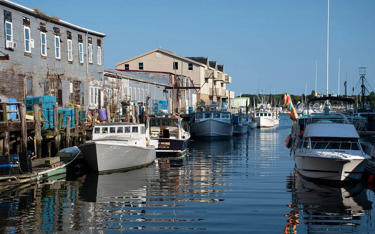 Portland, Maine's commercial street next to boats, water and shops.